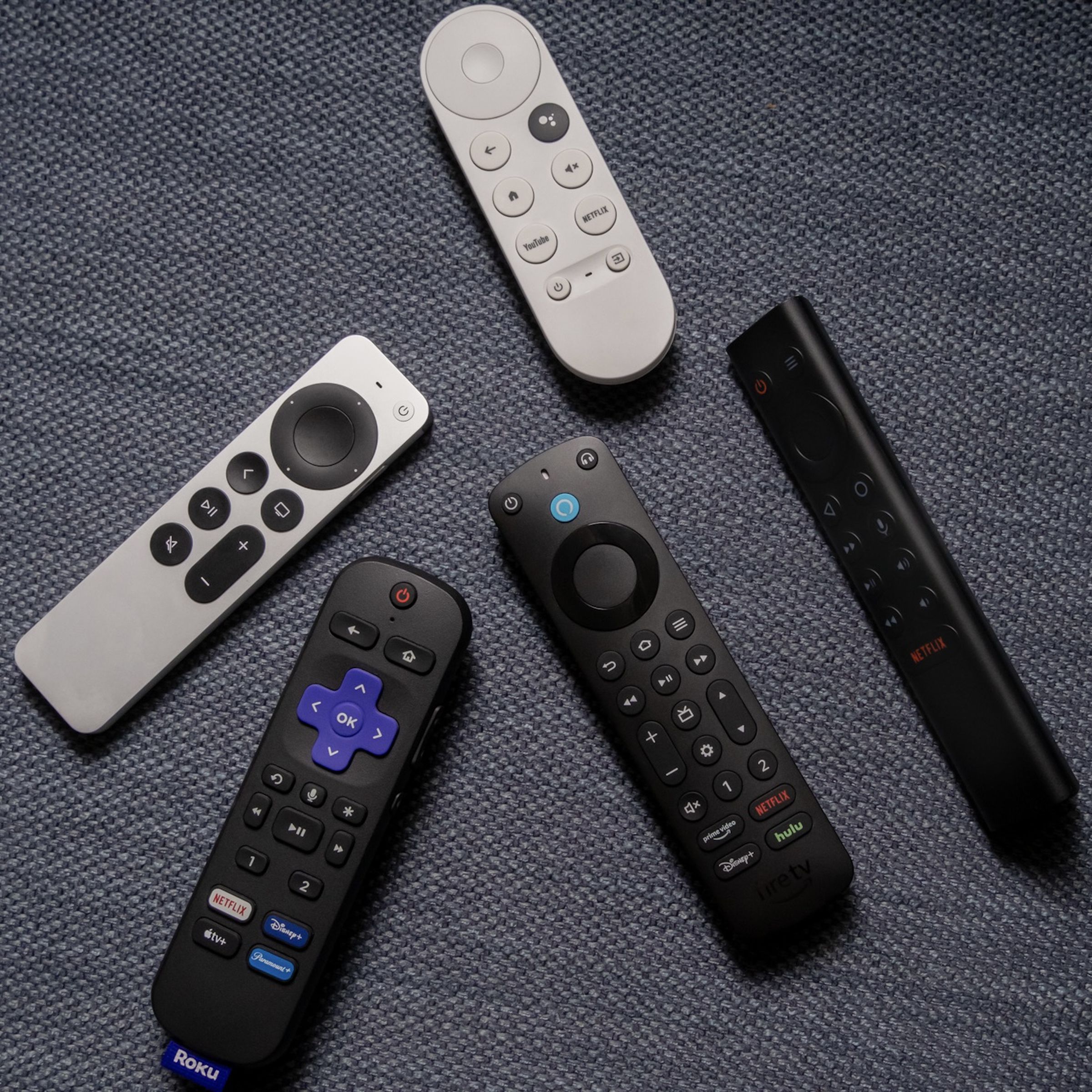 A photo of various remotes from Amazon, Apple, Roku, Google, and Nvidia.