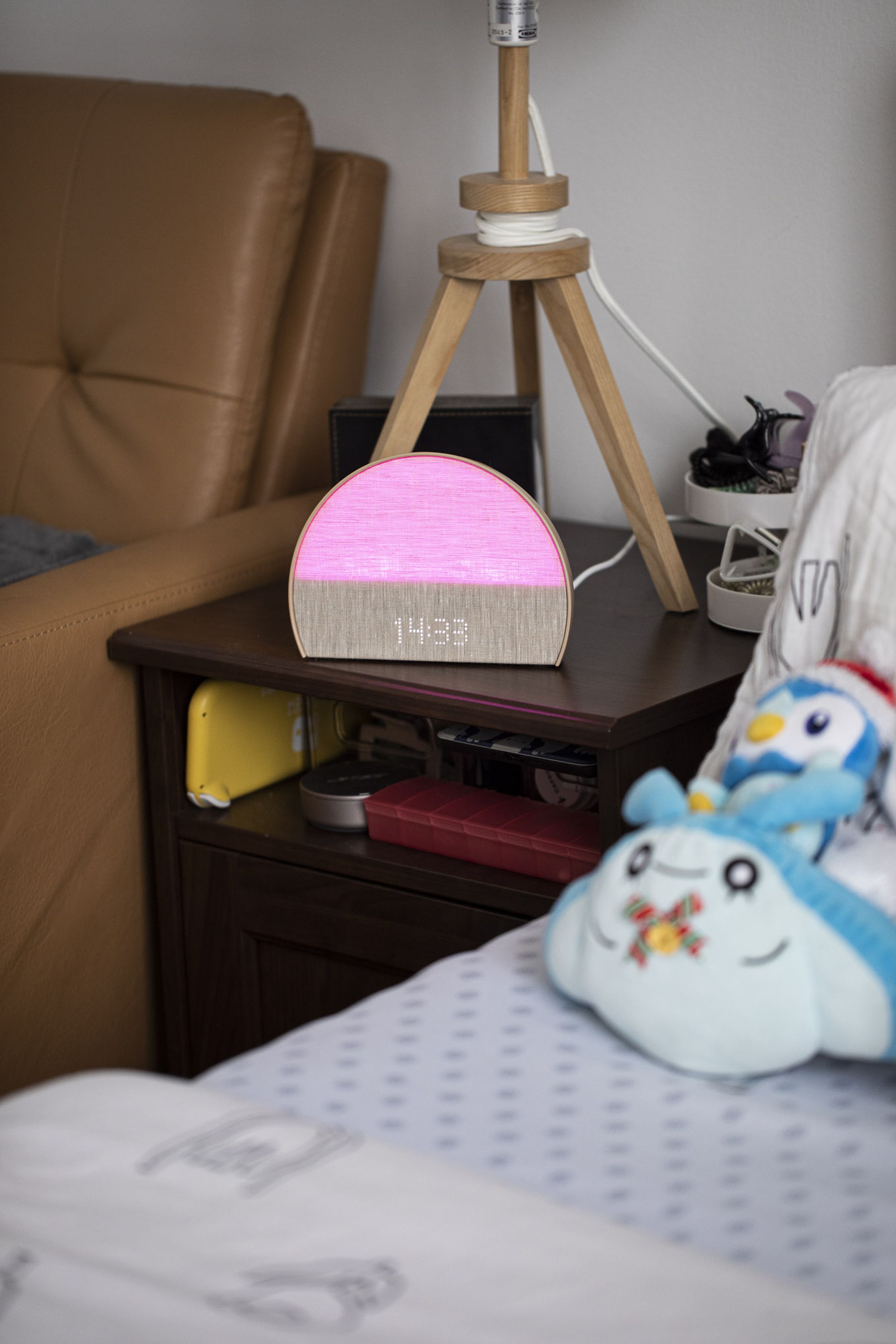 The Hatch Restore 2 on a nightstand with a pink light