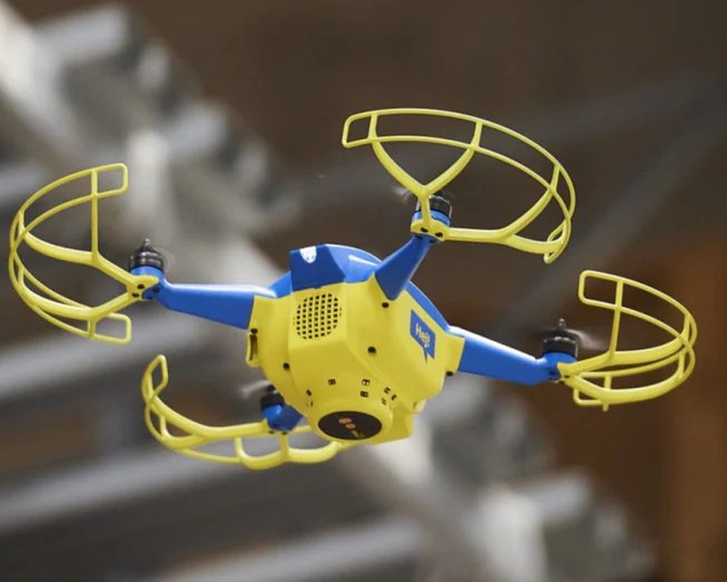 An image showing a blue and yellow drone in mid-air