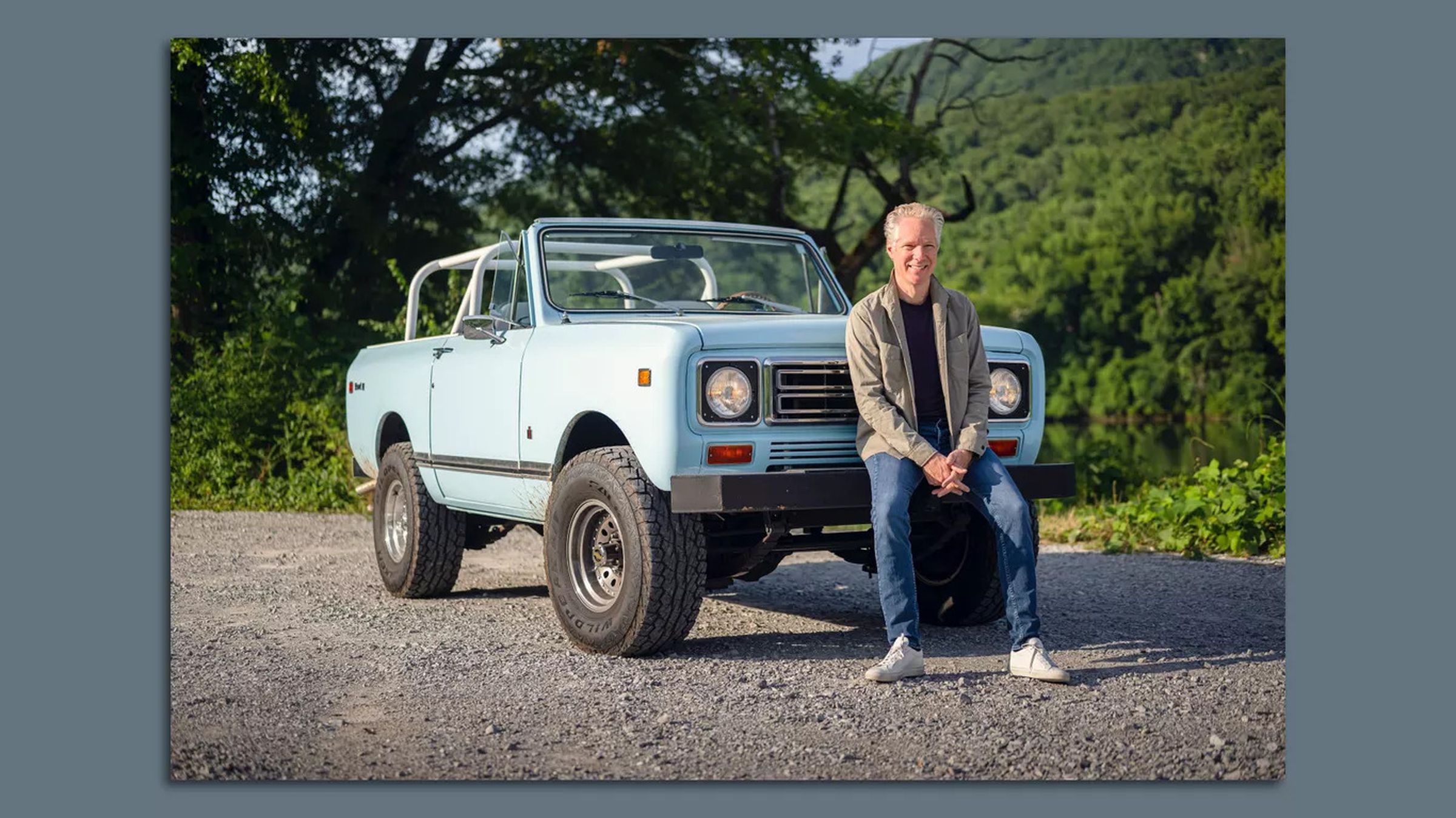 New Scout CEO and former head of Volkswagen Group America, Scott Keogh, stands in front of a classic International Harvester Scout vehicle.