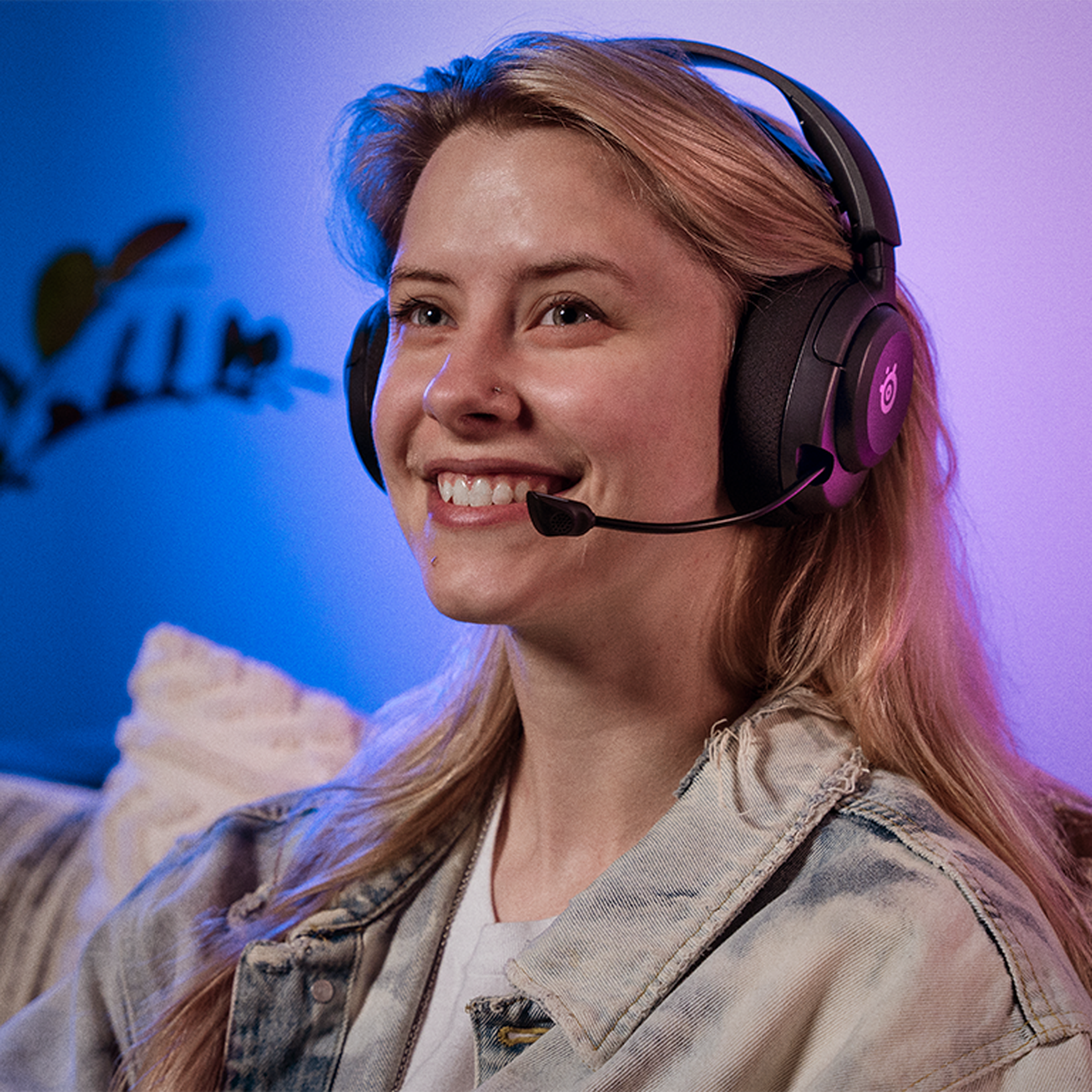 A person wearing the SteelSeries Arctis Nova 5 wireless headset.