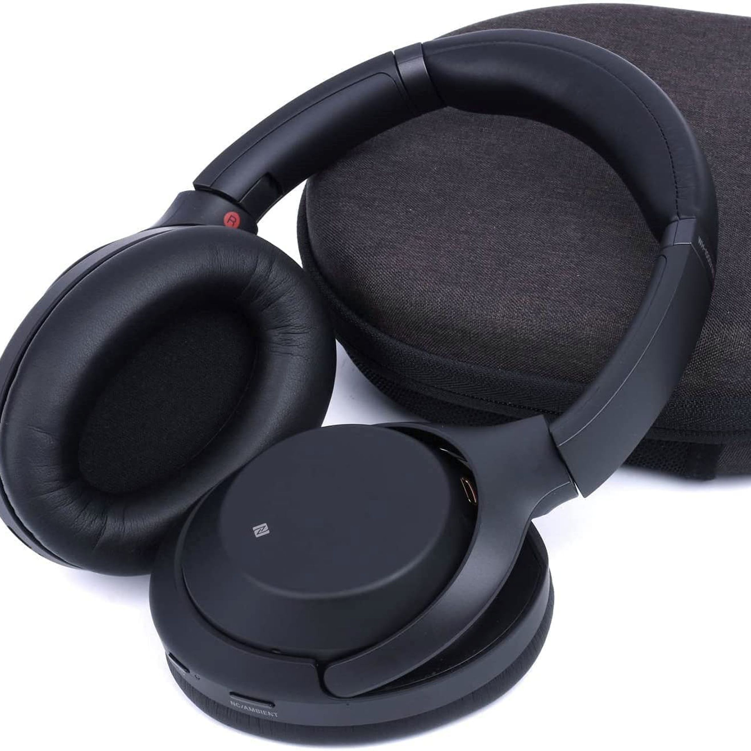 A pair of headphones leaning against a new headphone cushion.