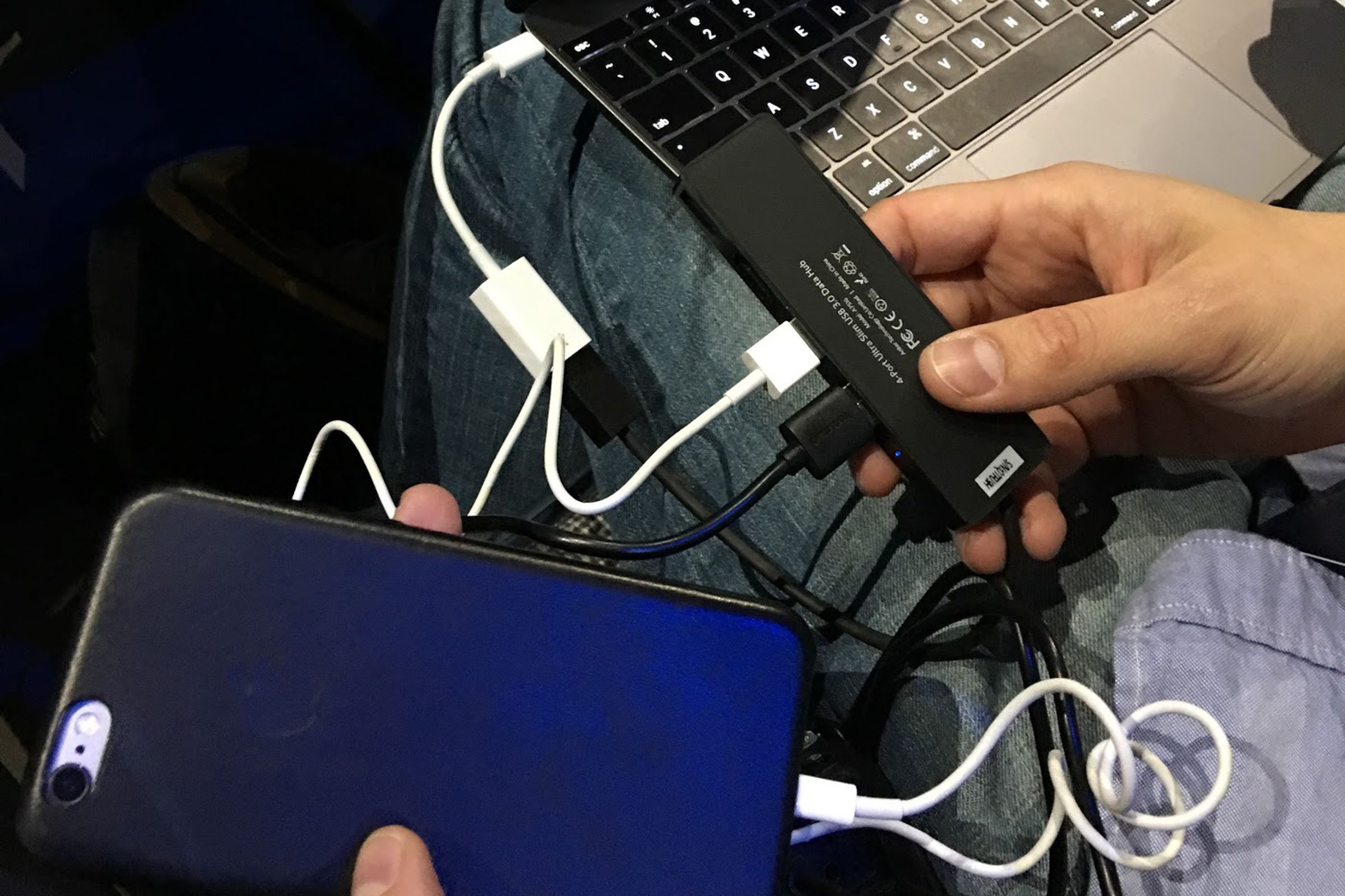 macbook with a bunch of dongles