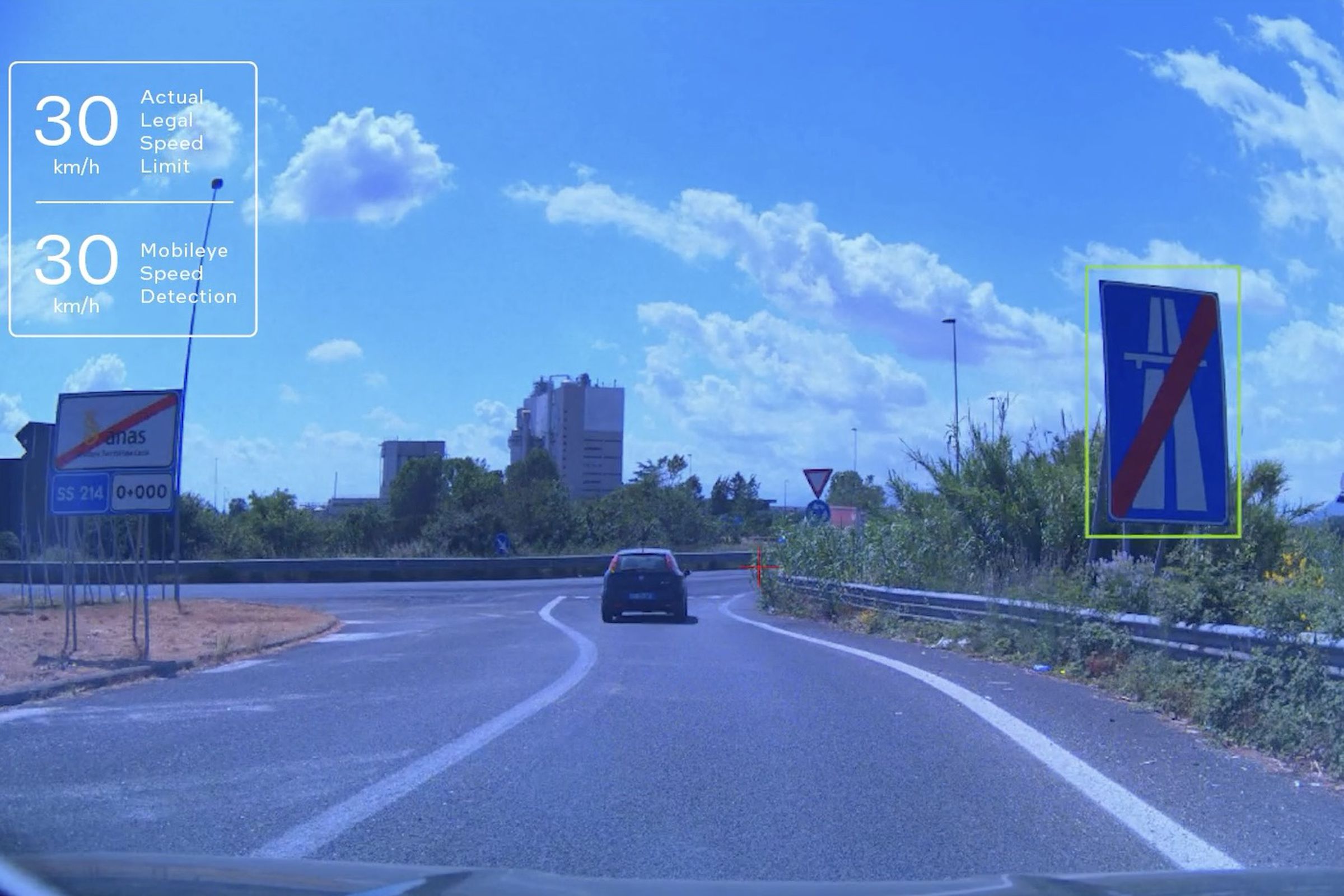 first person view on a road with a sign that has computer boxes drawn around it showing the system is reading it.