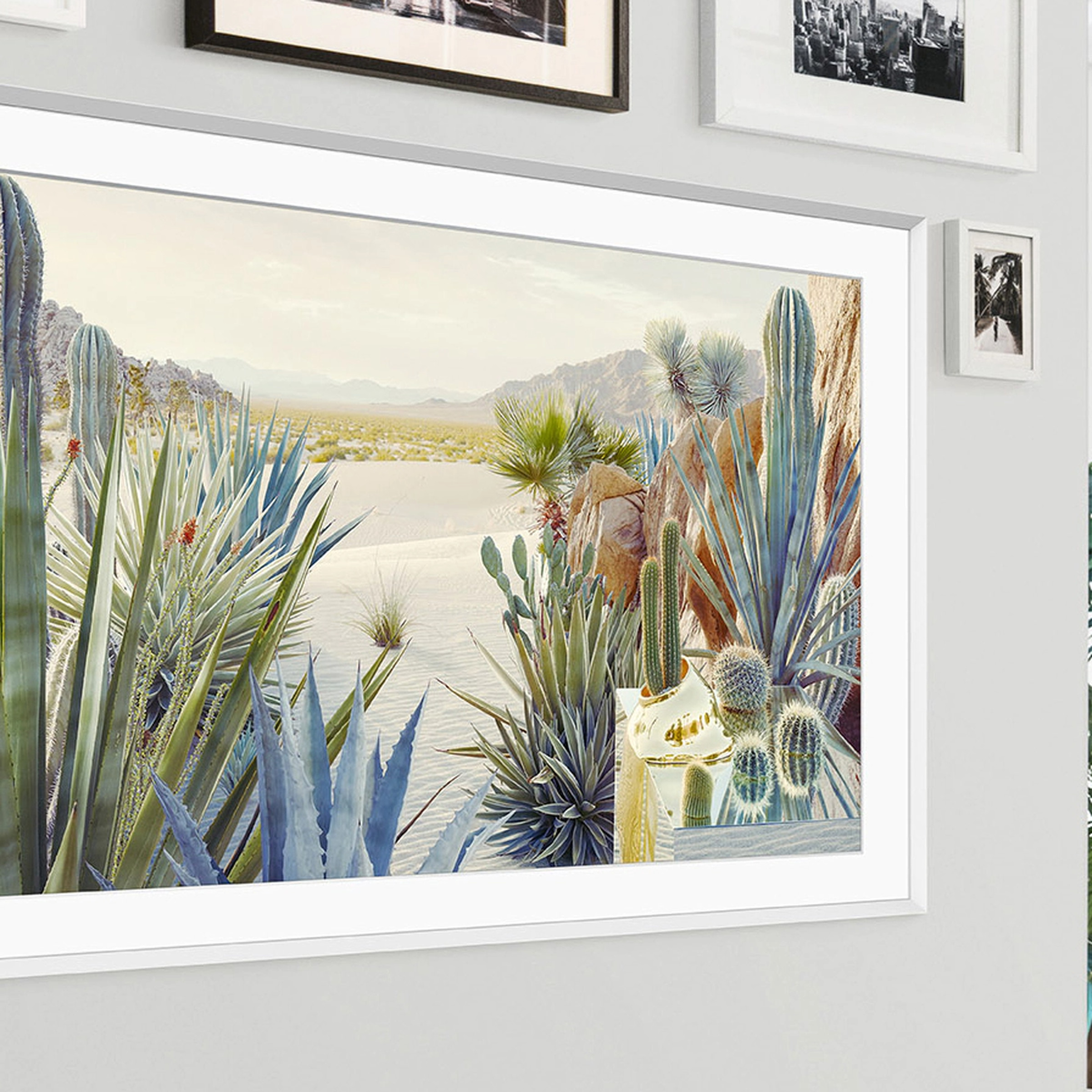 A close-up image of Samsung’s 2022 Frame TV hanging on a wall with a bunch of cacti on display.
