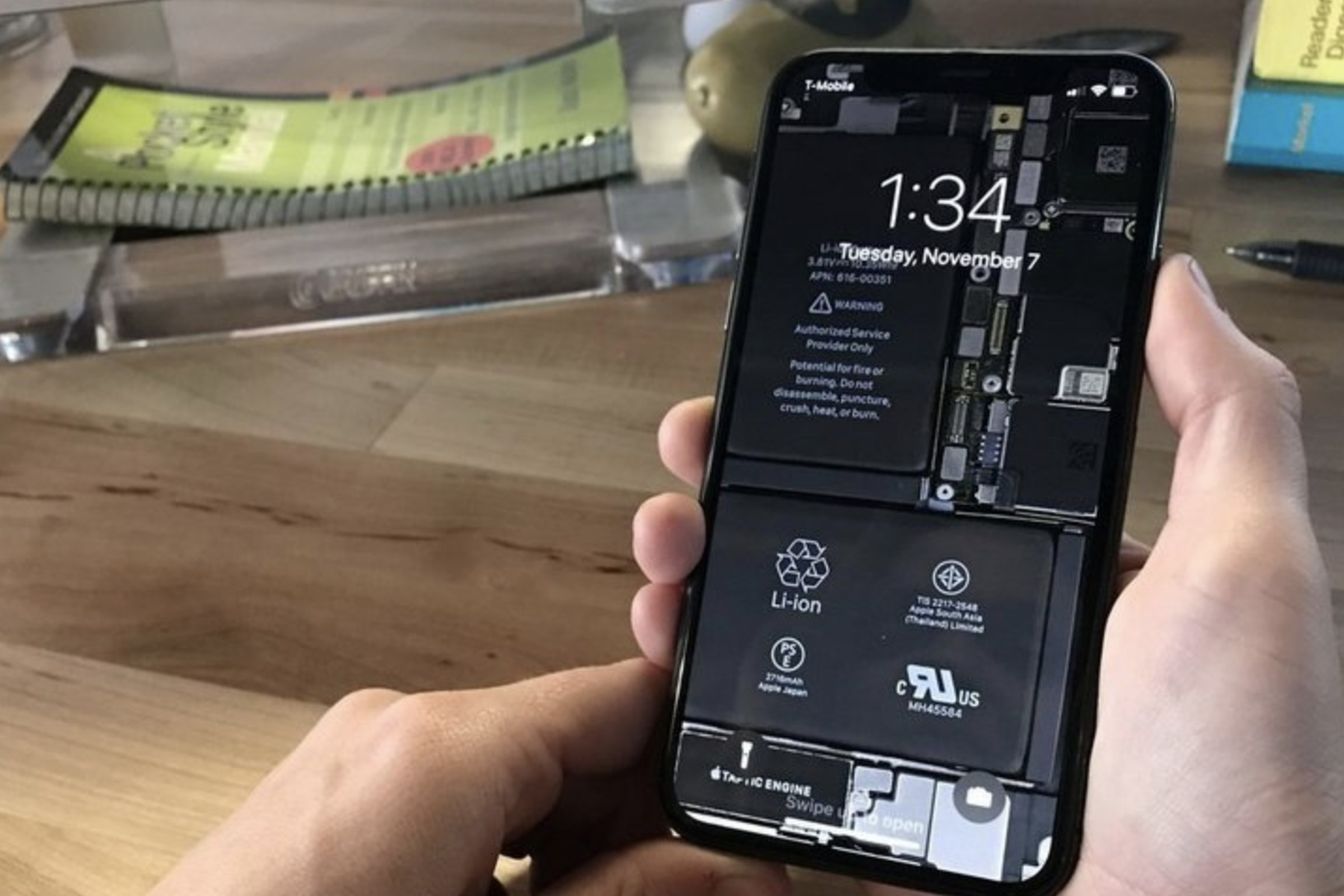 iFixit employee fixing a broken iPhone 15 screen. 