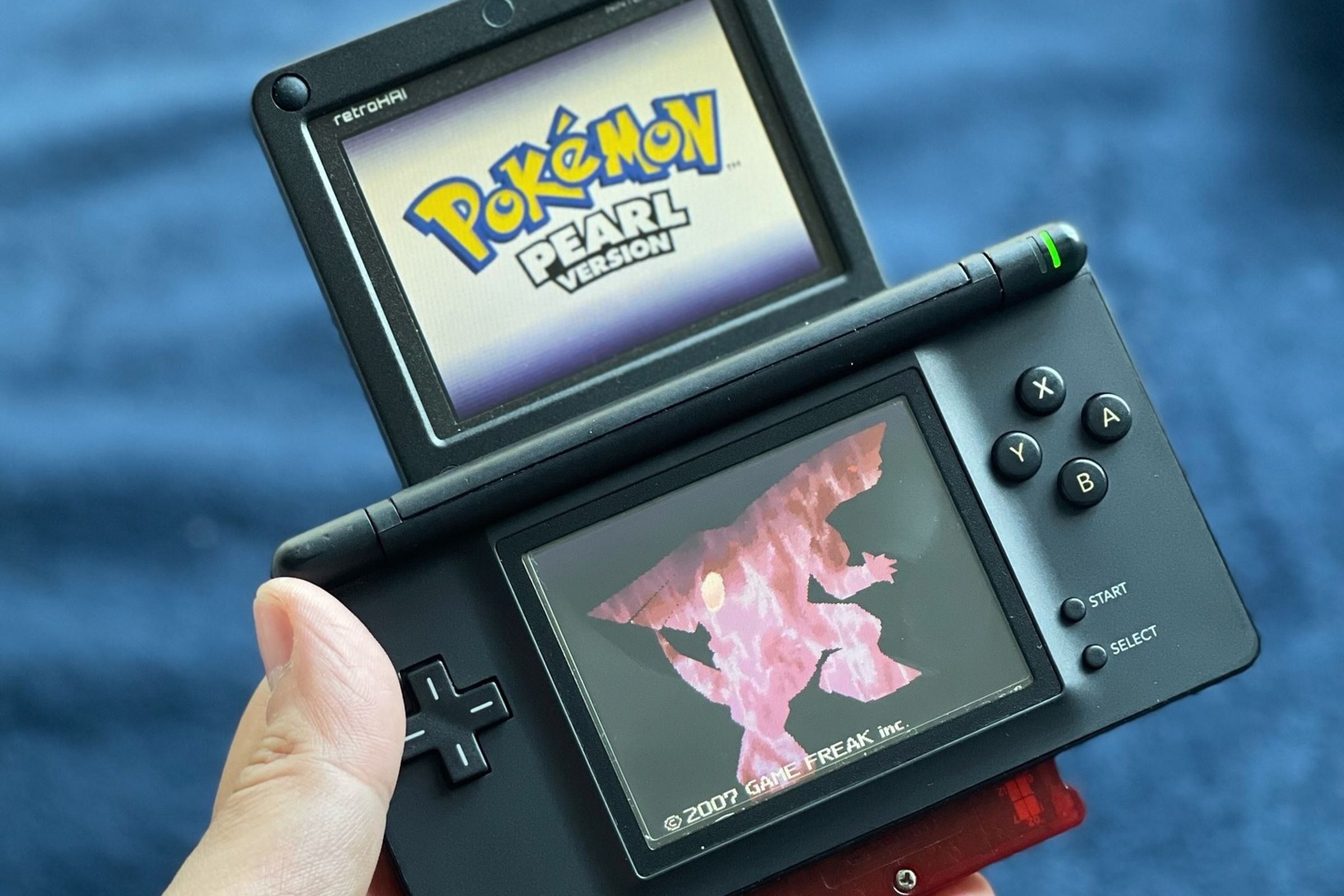 A picture of a Nintendo DS Lite that has had its top screen replaced by one from a Game Boy Advance SP