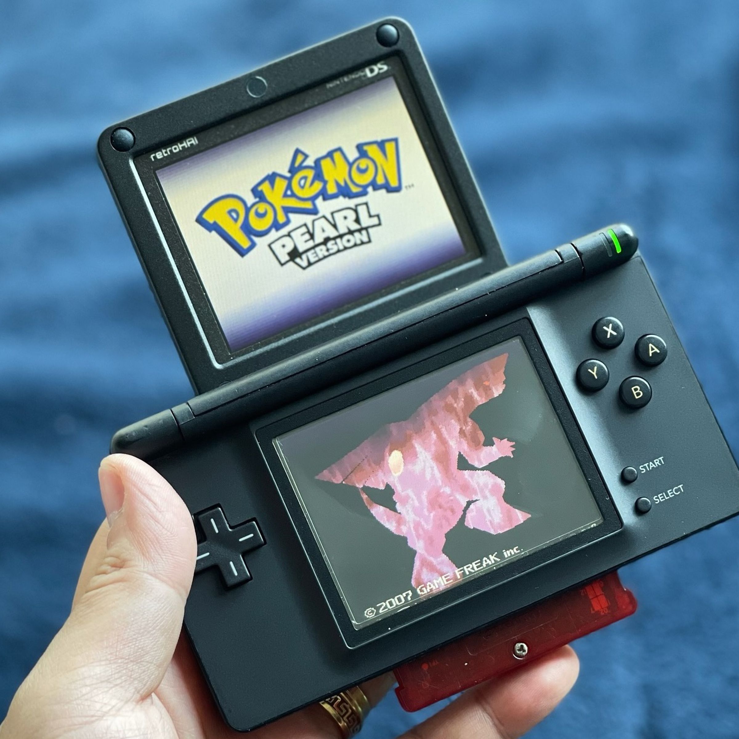 A picture of a Nintendo DS Lite that has had its top screen replaced by one from a Game Boy Advance SP