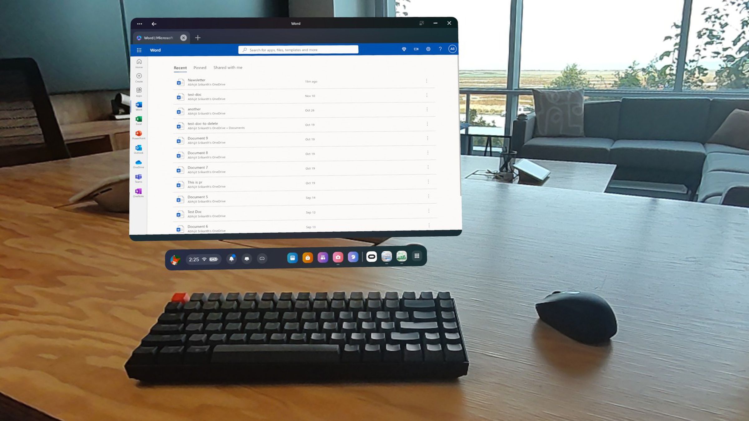 A photo showing a Microsoft Word window in VR over a keyboard in a conference room.