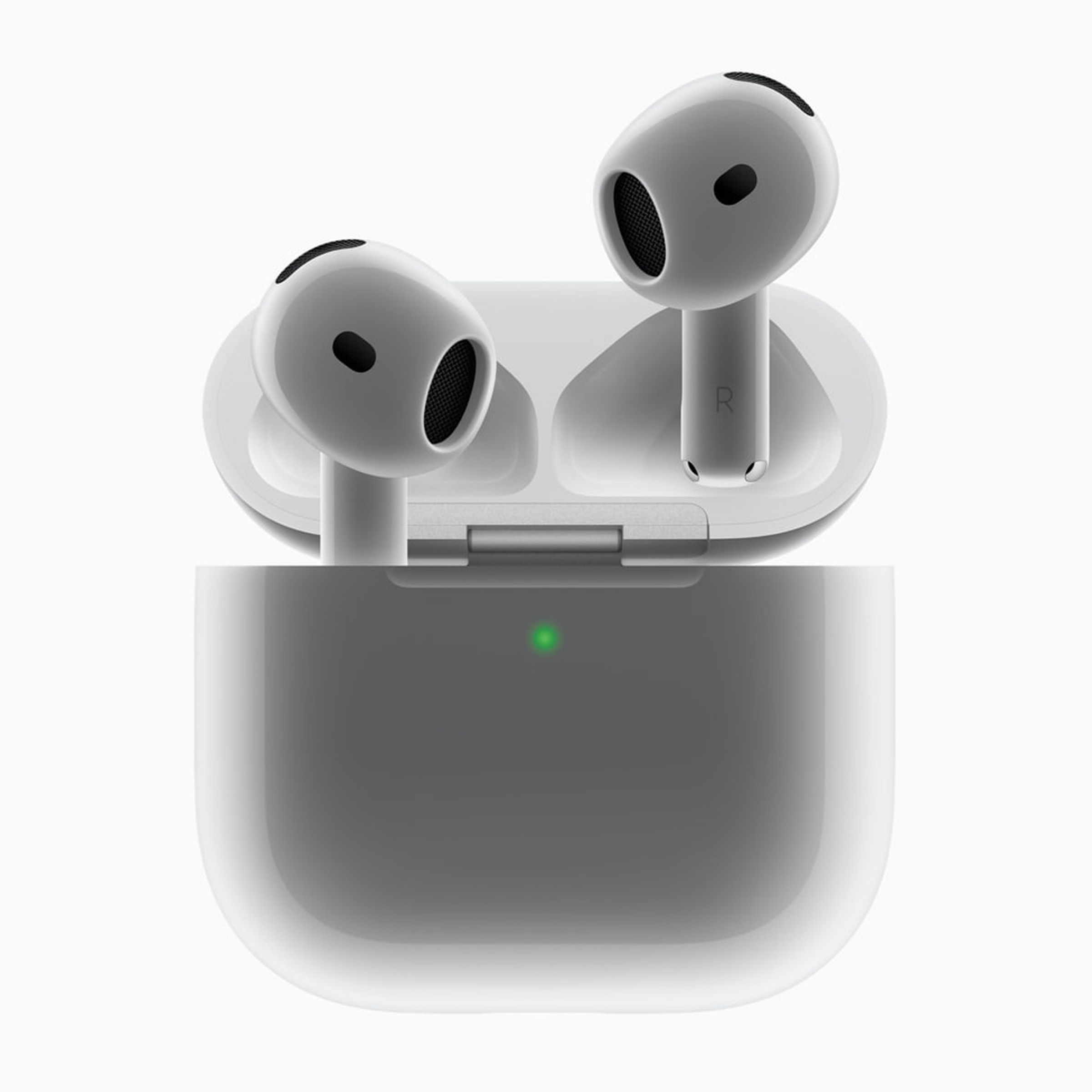 A close-up image of Apple’s AirPods 4 coming out of their case against a gray background.