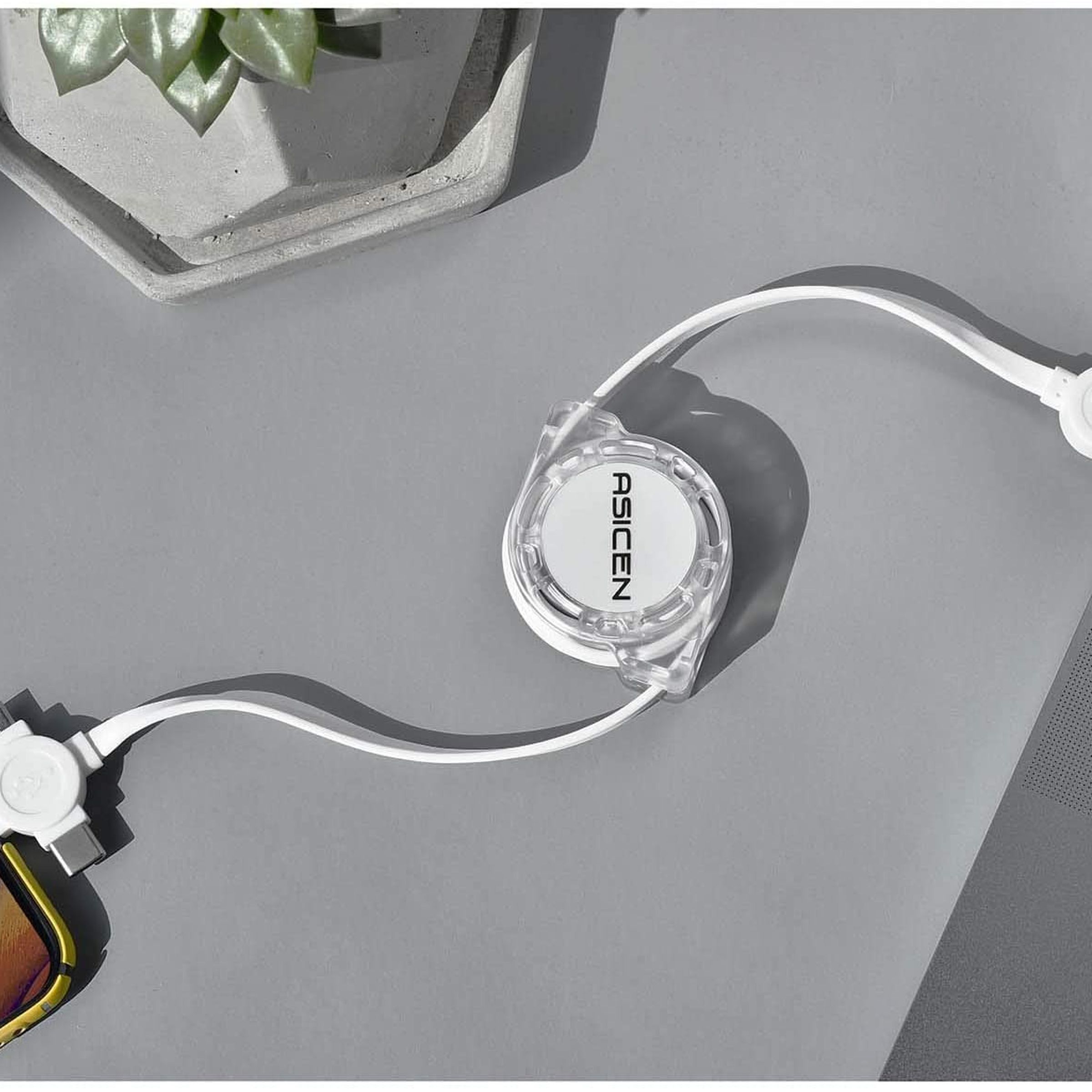 The Asicen retractable 3-in-1 charging cable plugged into a phone and laptop.