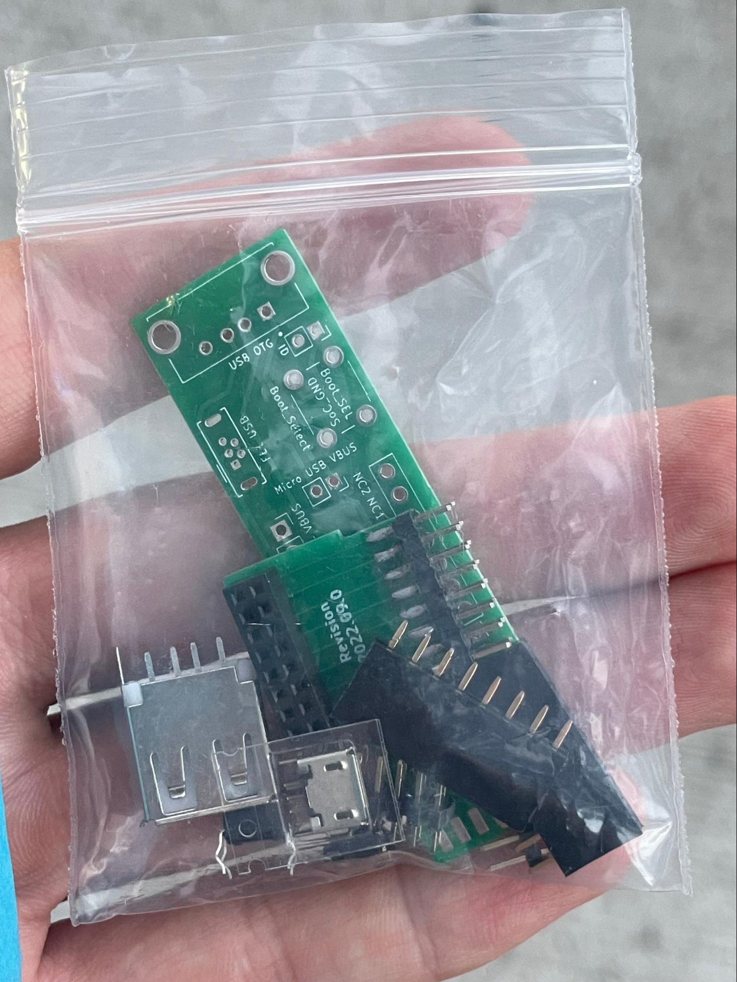 A ziplock bag with PCBs, transistors, and other parts necessary to build the breakout board.