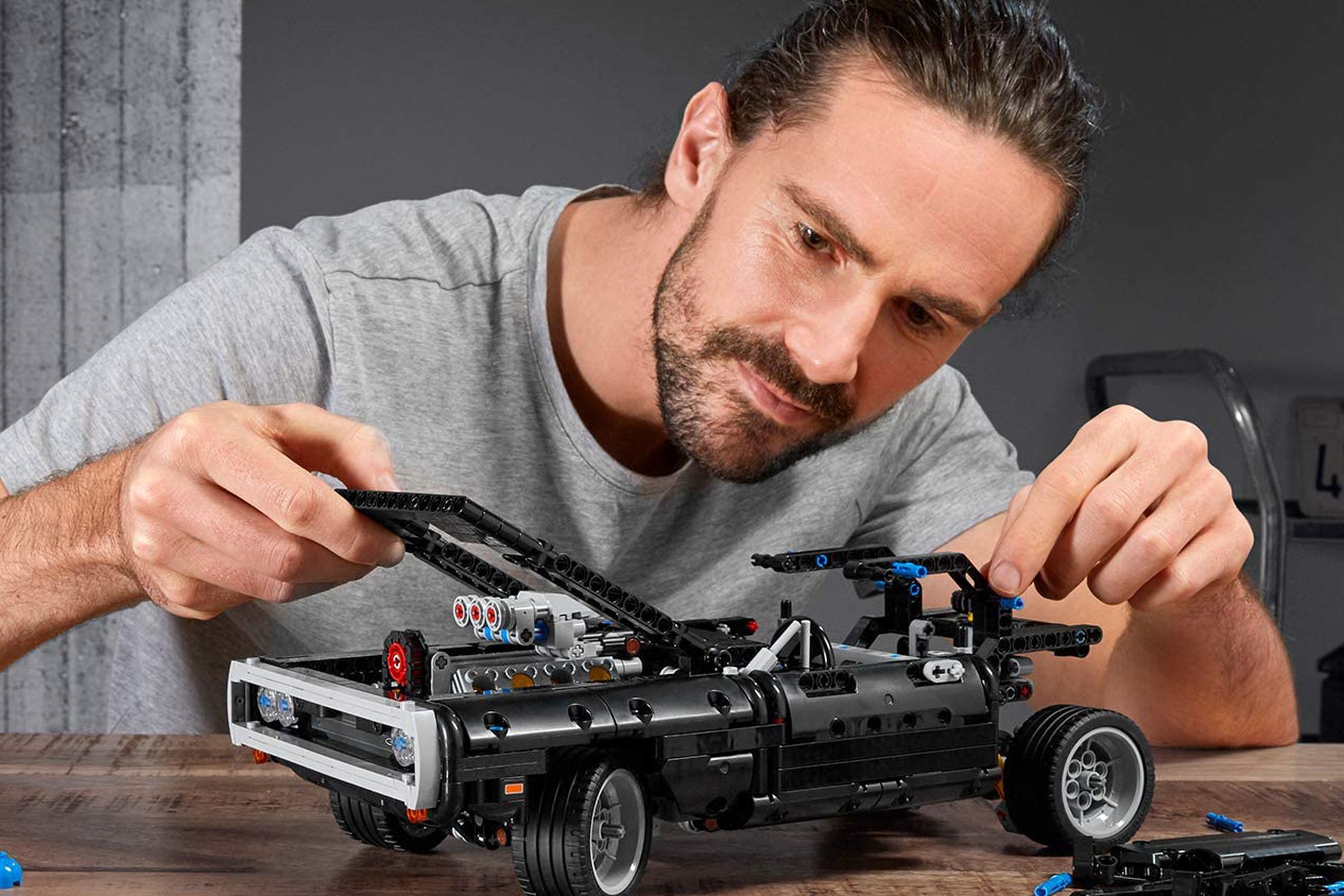 A photo of a person assembling a Lego Technics