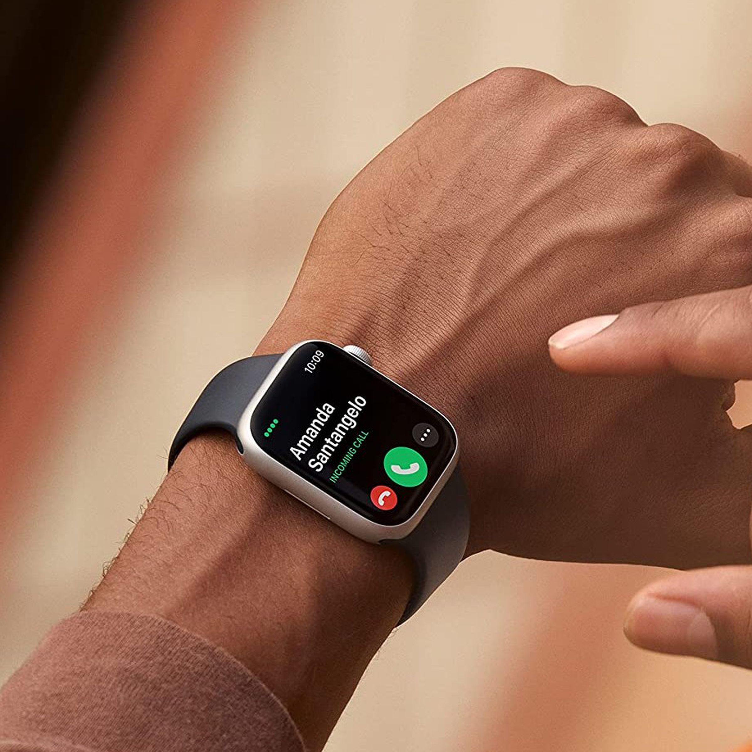 Somebody wearing and about to tap on the Apple Watch Series 8.