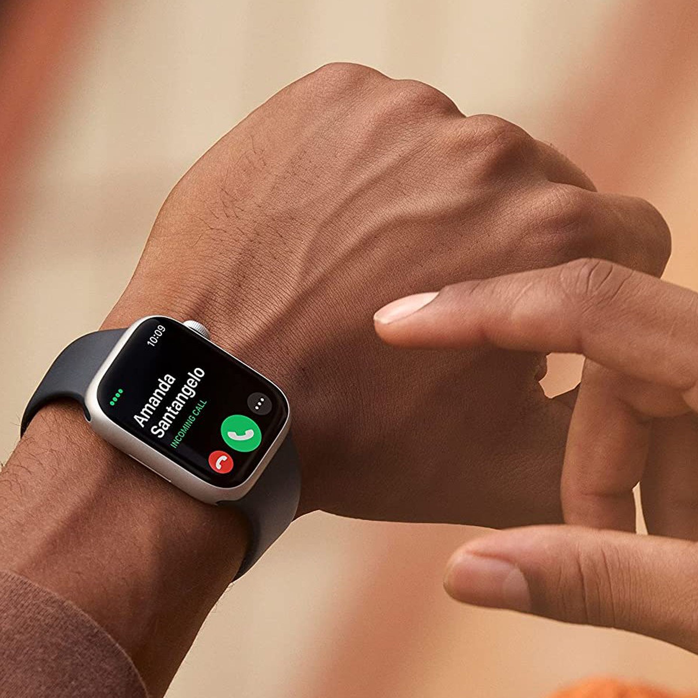 Someone wearing and about to touch the Apple Watch Series 8.
