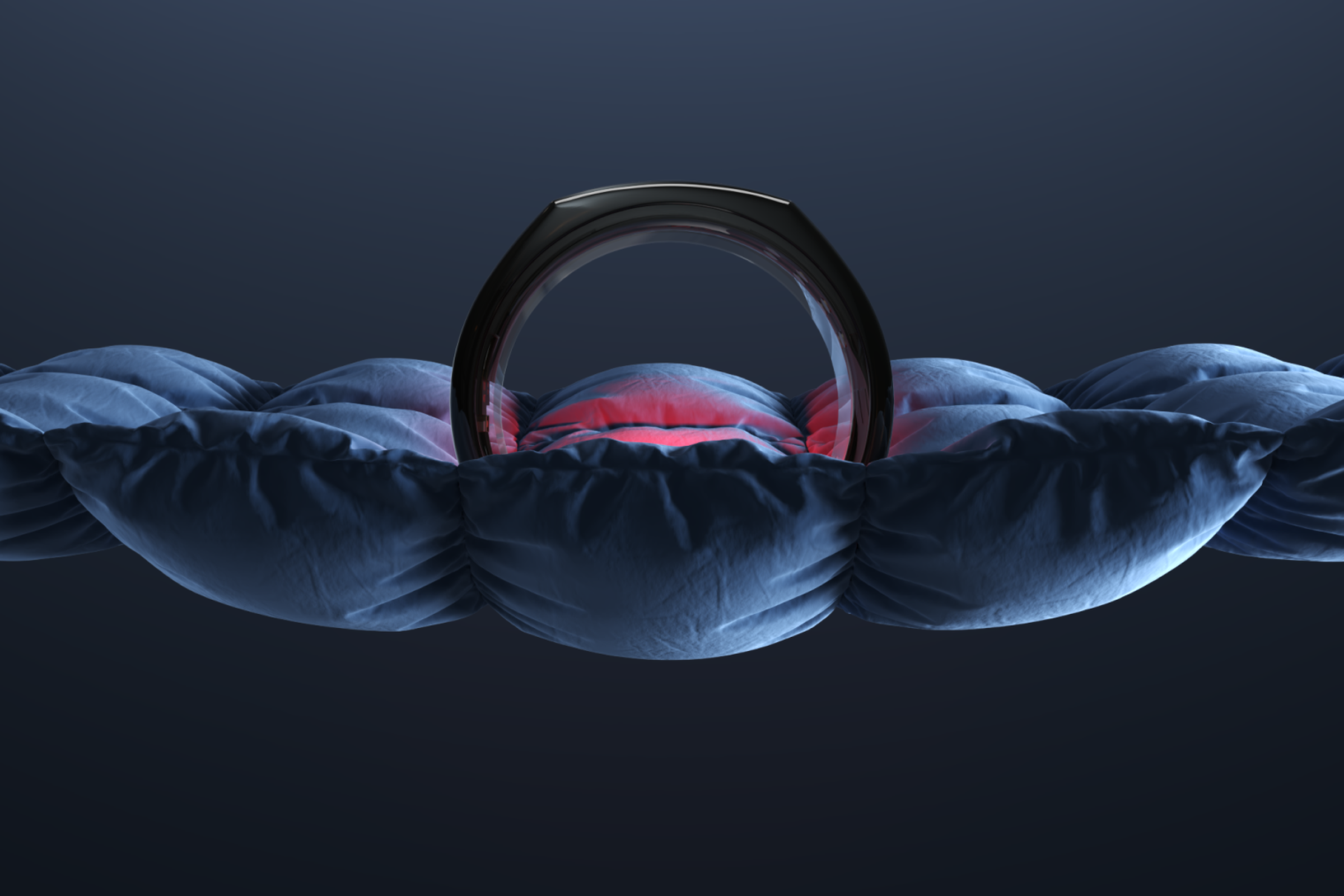 The Oura Ring on top of a blanket with the red SpO2 sensors lit up