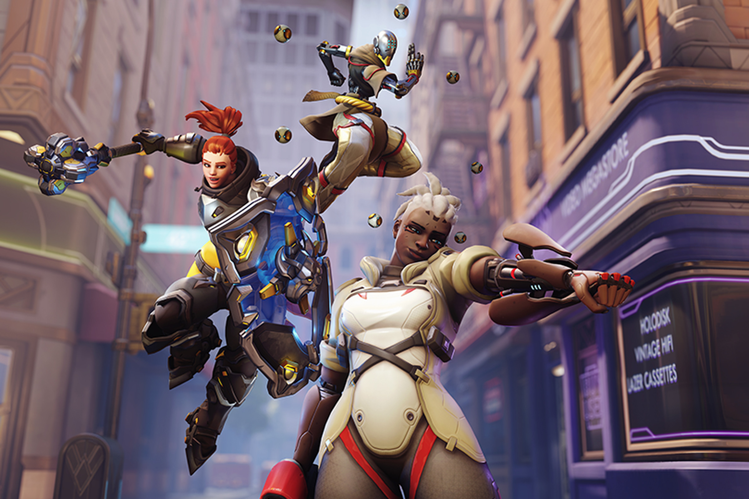 Promotional image from Overwatch 2 featuring heroes Sojourn, Brigitte, and Zenyatta in action poses.