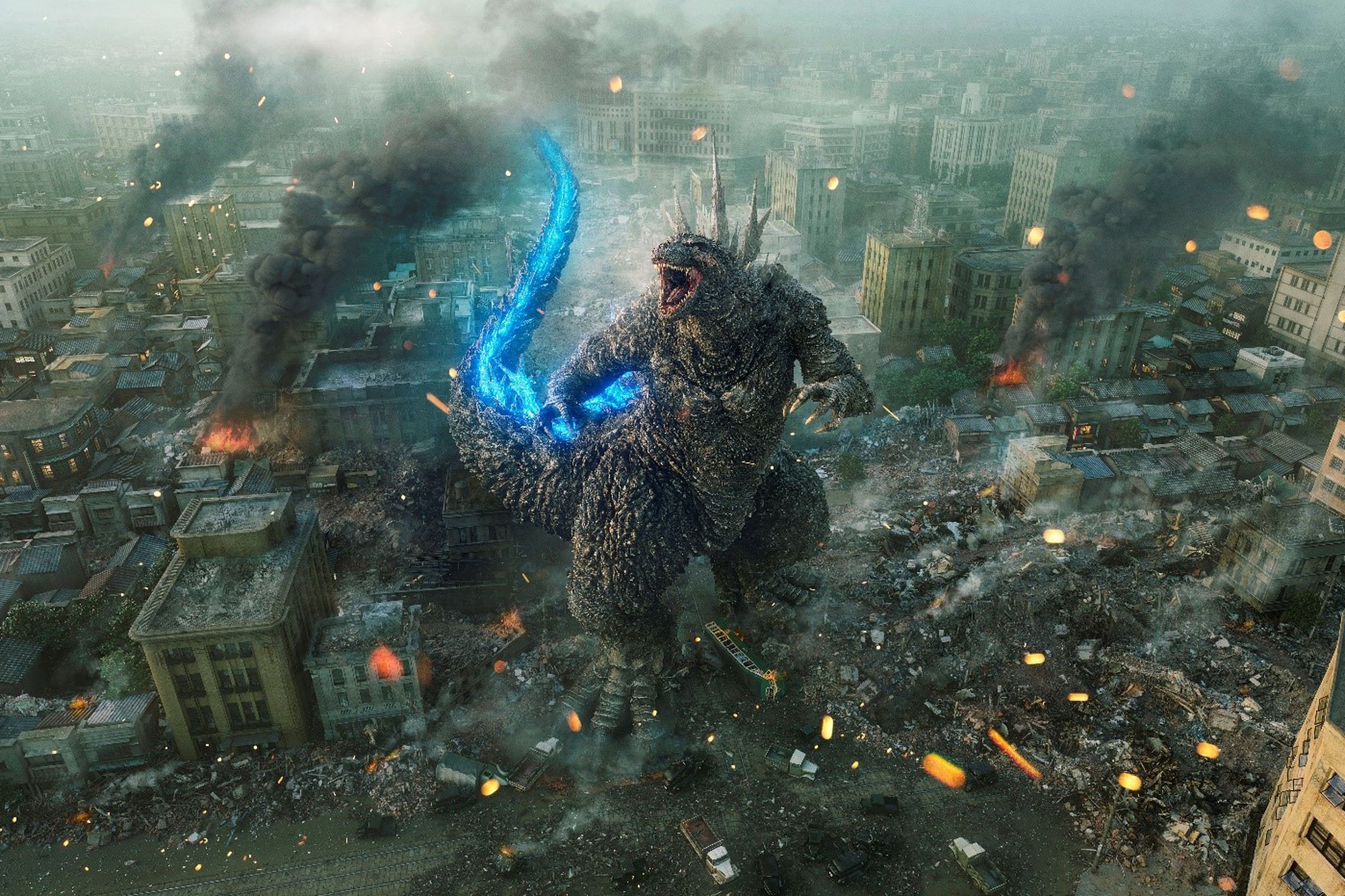 A wide, aerial shot of a gargantuan, upright, dinosaur-like creature roaring up into the sky as a ruined city smolders around it.
