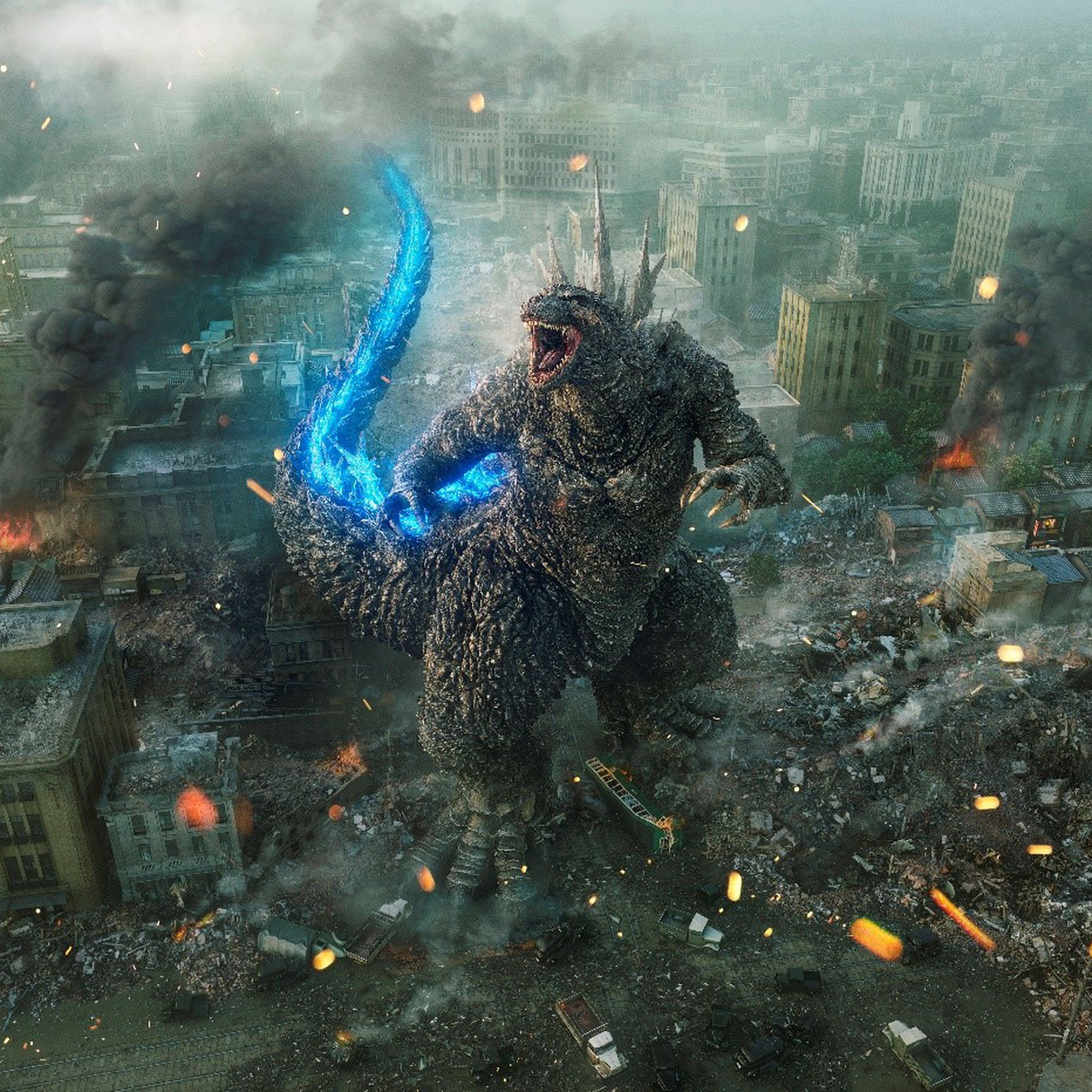 A wide, aerial shot of a gargantuan, upright, dinosaur-like creature roaring up into the sky as a ruined city smolders around it.