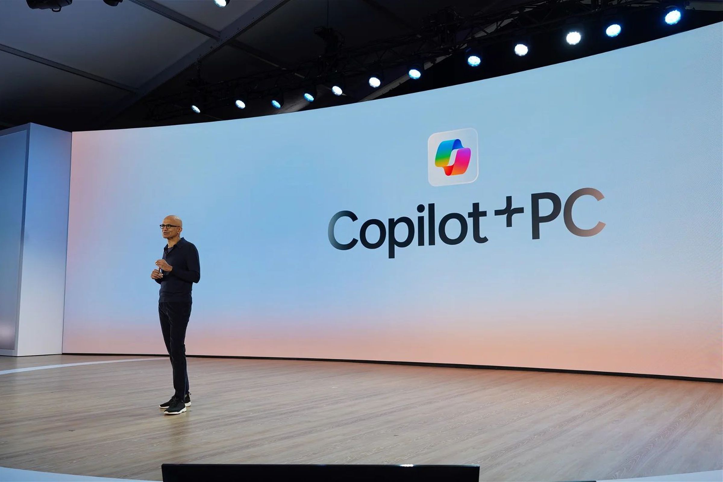 Microsoft CEO Satya Nadella standing in front of a screen reading “Copilot+PC”