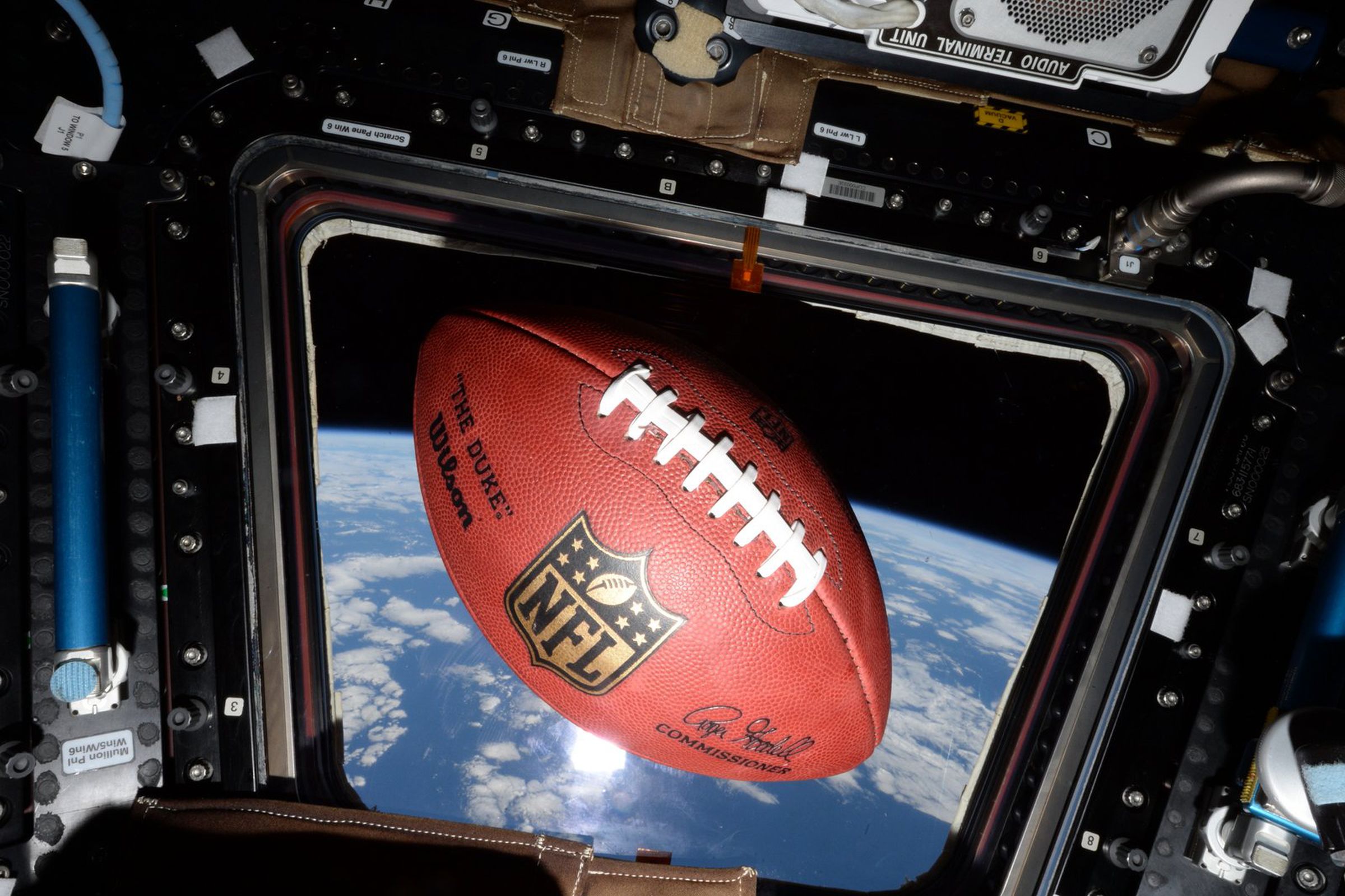 A football floating on the International Space Station