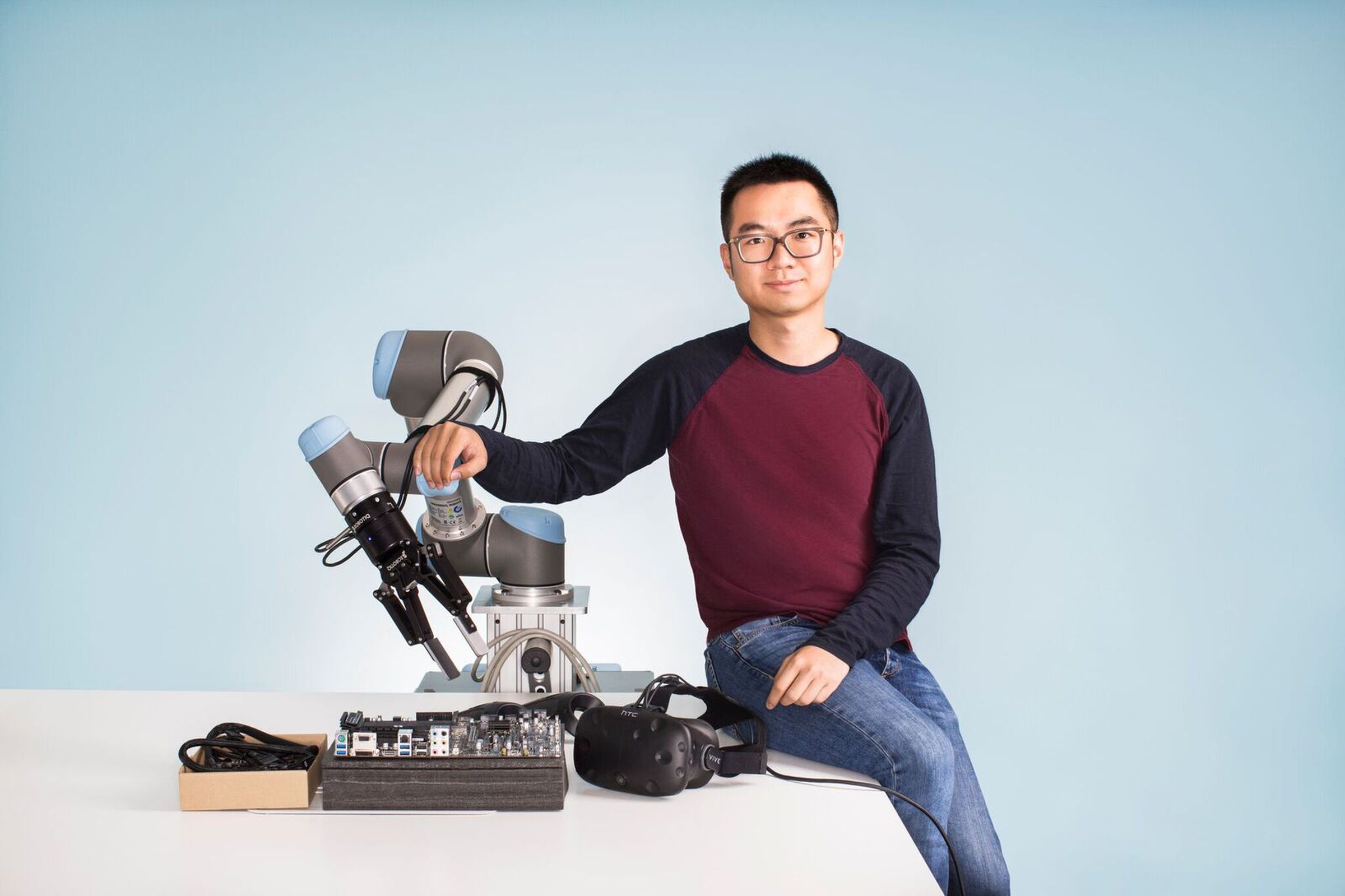 Peter Chen of Embodied Intelligence with a test robot and VR headset.