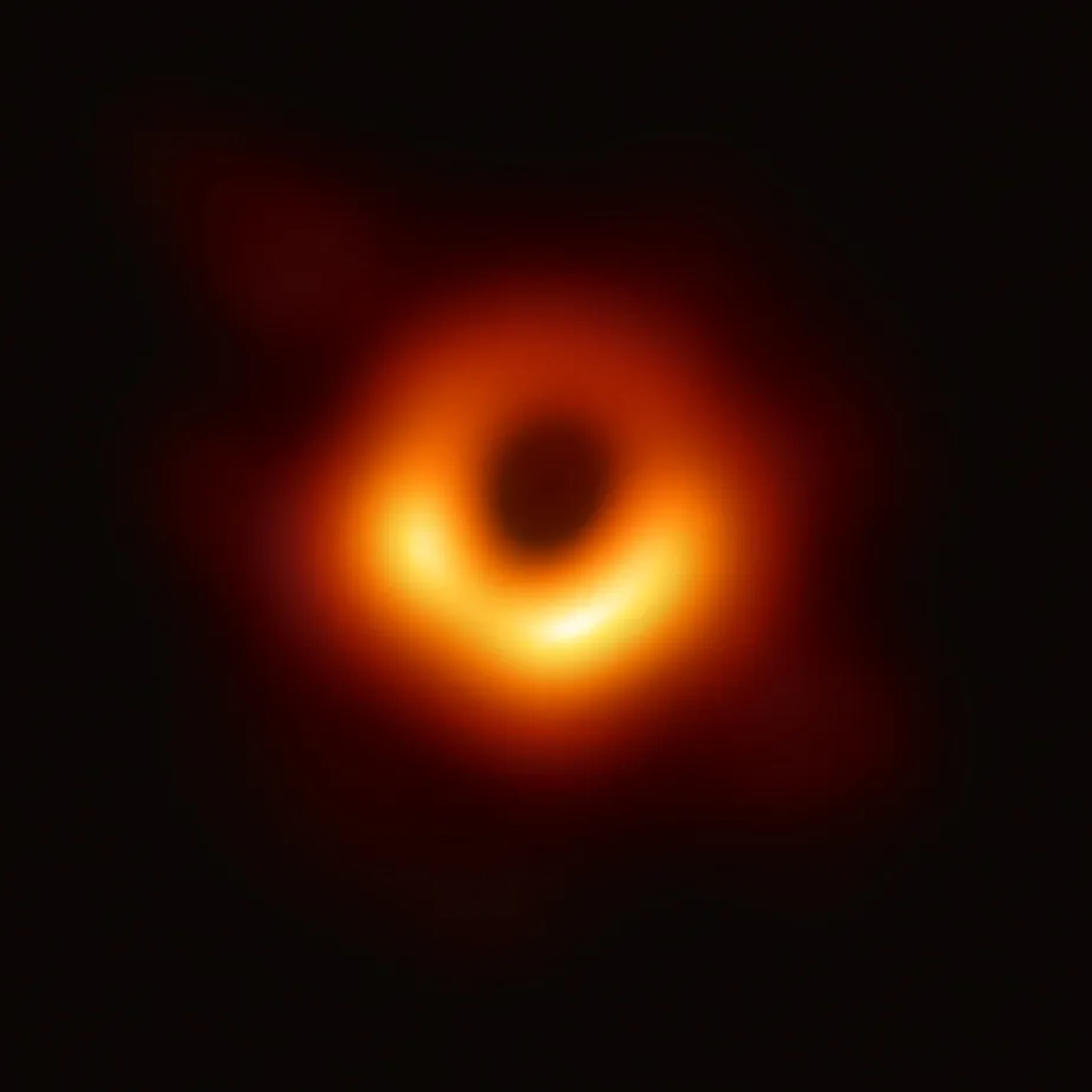 The first image of a black hole — a fuzzy, orange and red ring against a black backdrop.