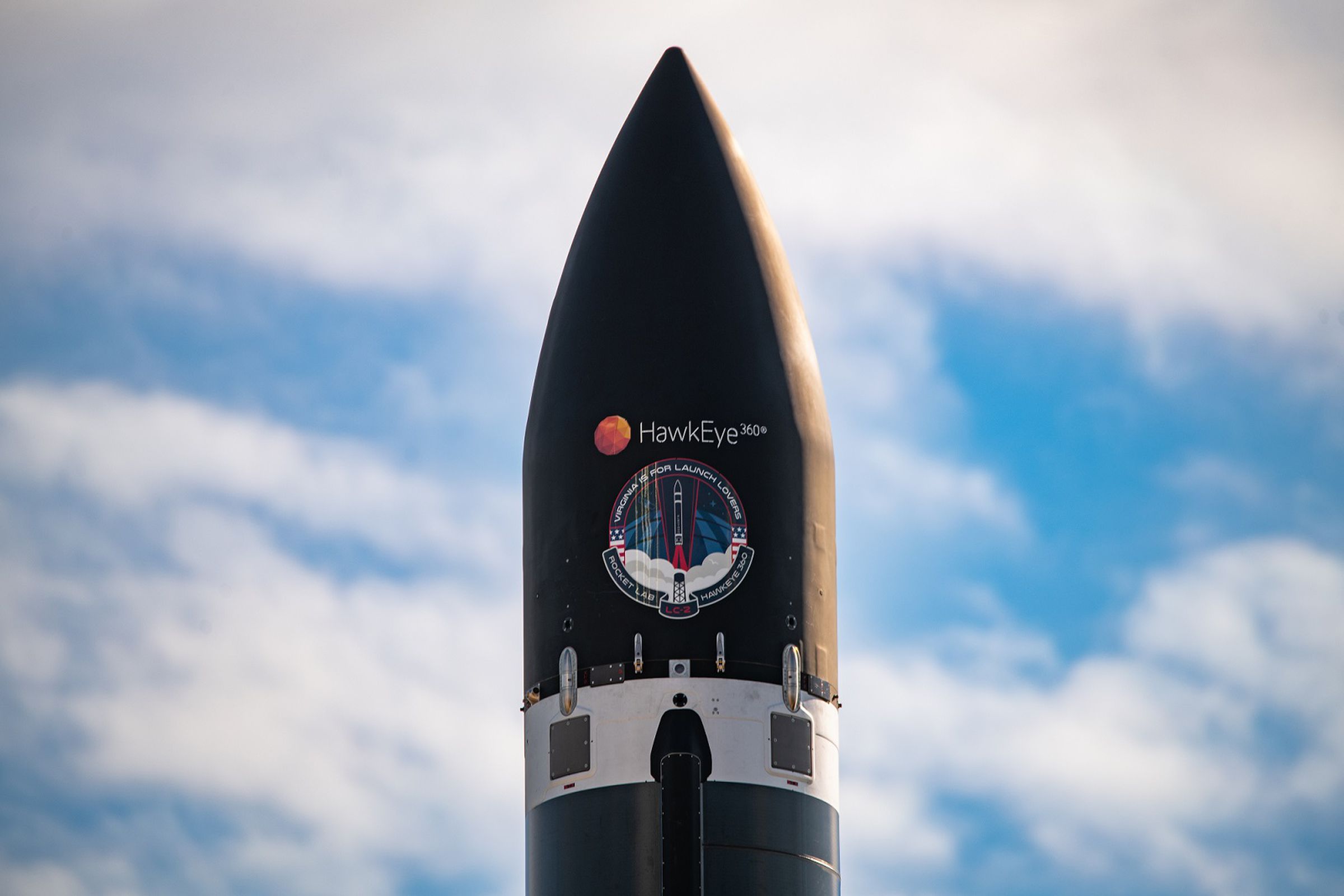 The top of Rocket Lab’s Electron rocket displaying the company logo for HawkEye 360