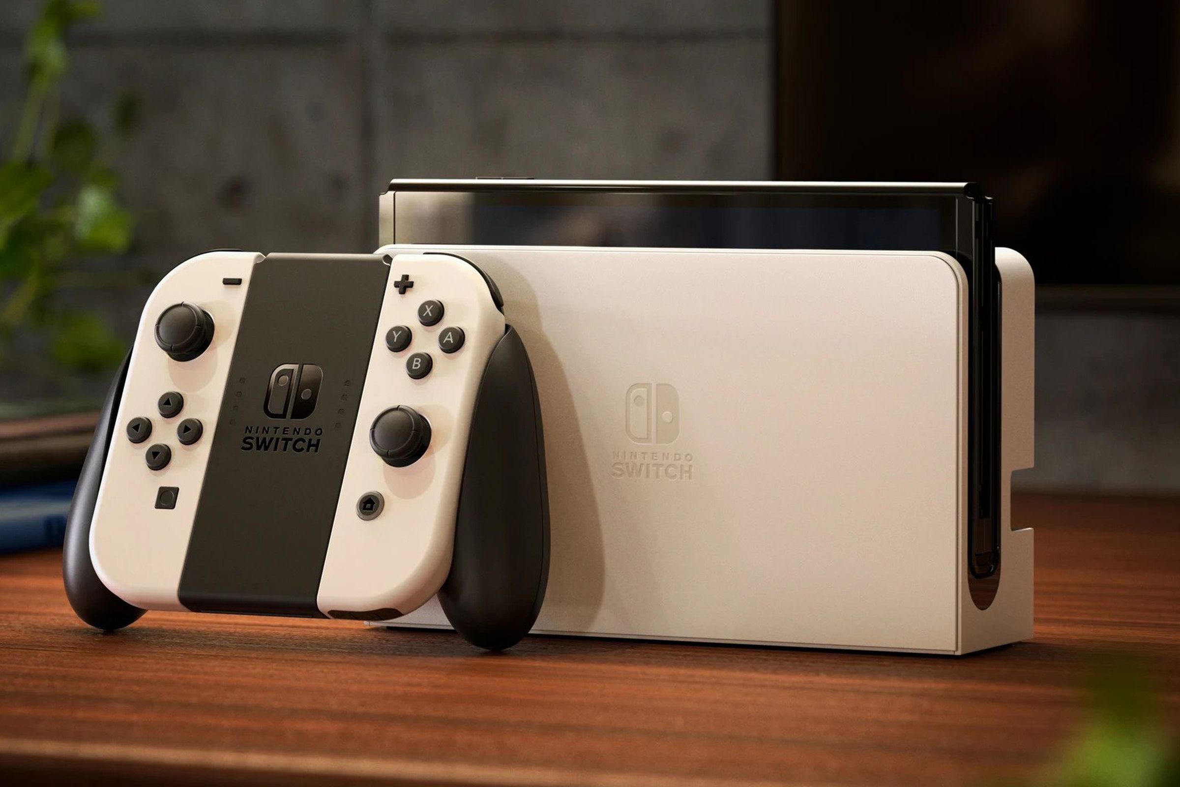 Nintendo’s Switch OLED model in white with its updated dock and accompanying Joy-Cons.