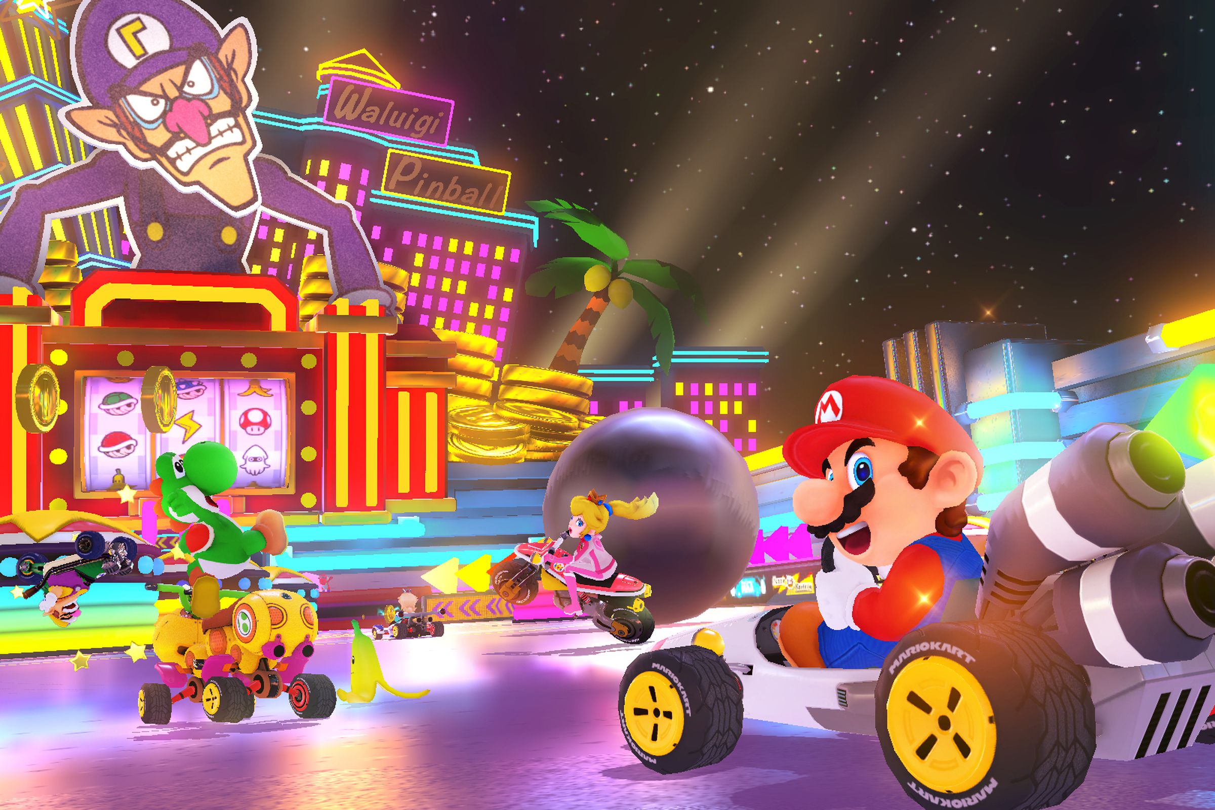 An image of Mario, Yoshi, and other Mario Kart characters driving on a course that resembles a pinball machine.