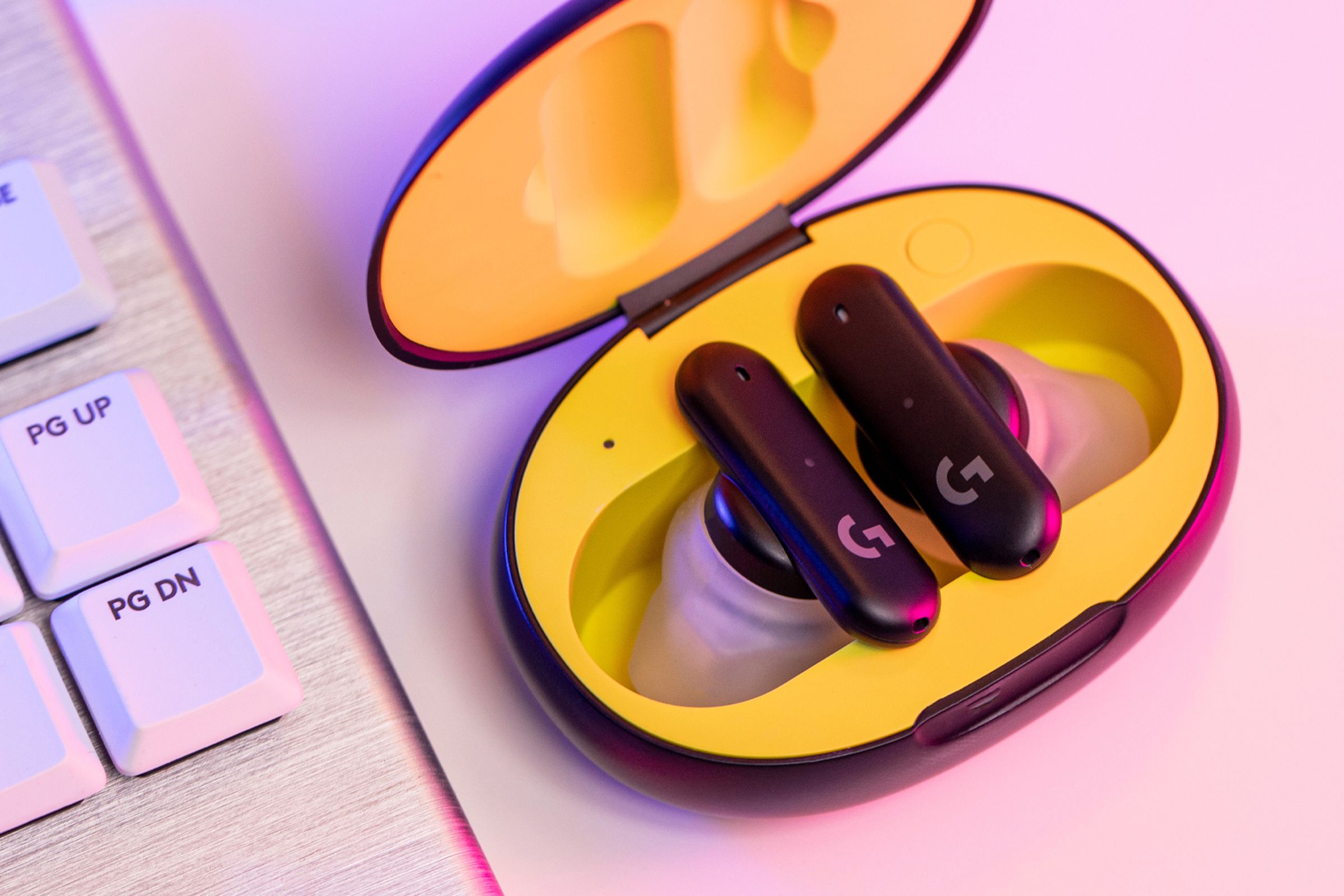 The Logitech G Fits wireless earbuds sitting in an opened yellow case.