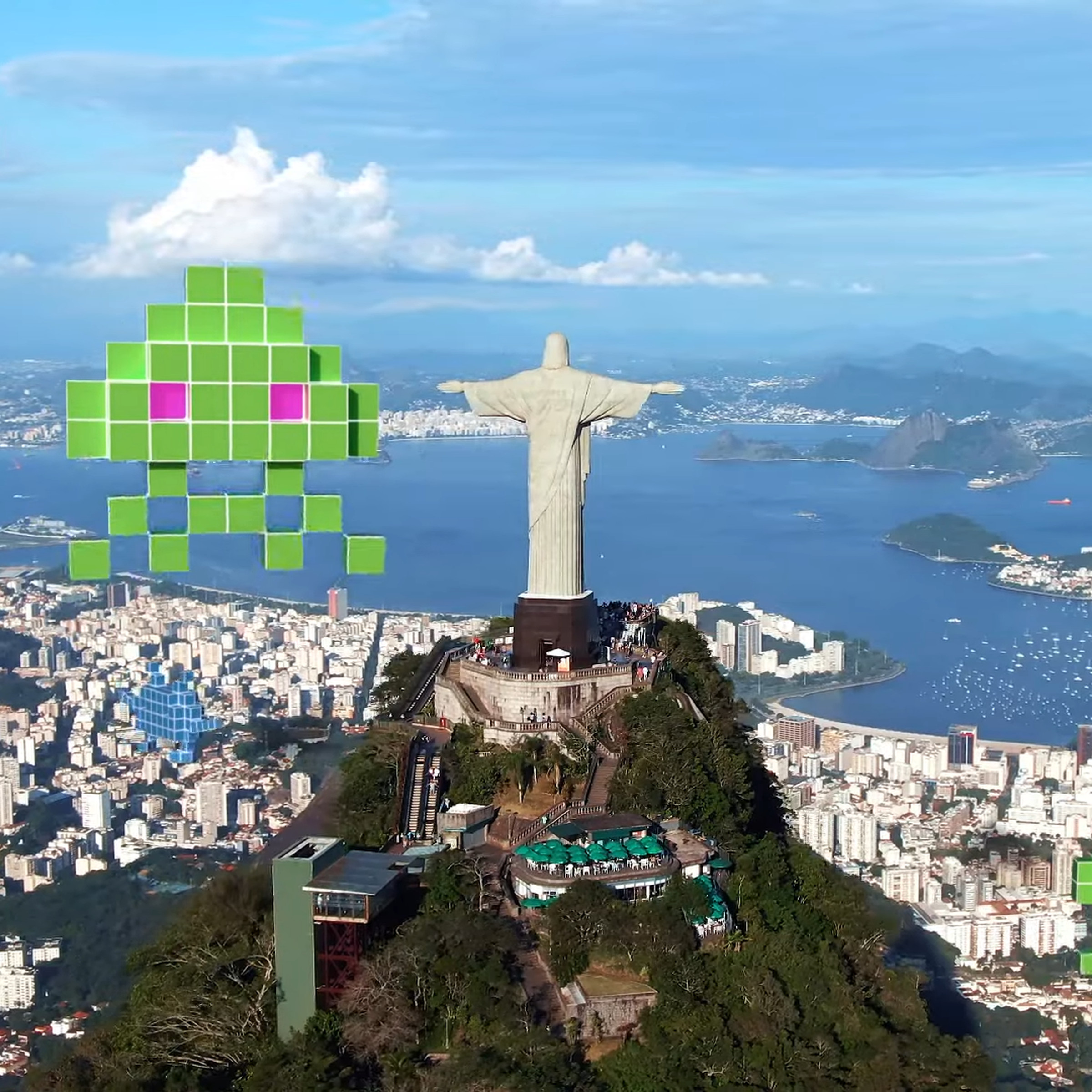 A photo of the Christ the Redeemer statue surrounded by virtual Space Invaders aliens.