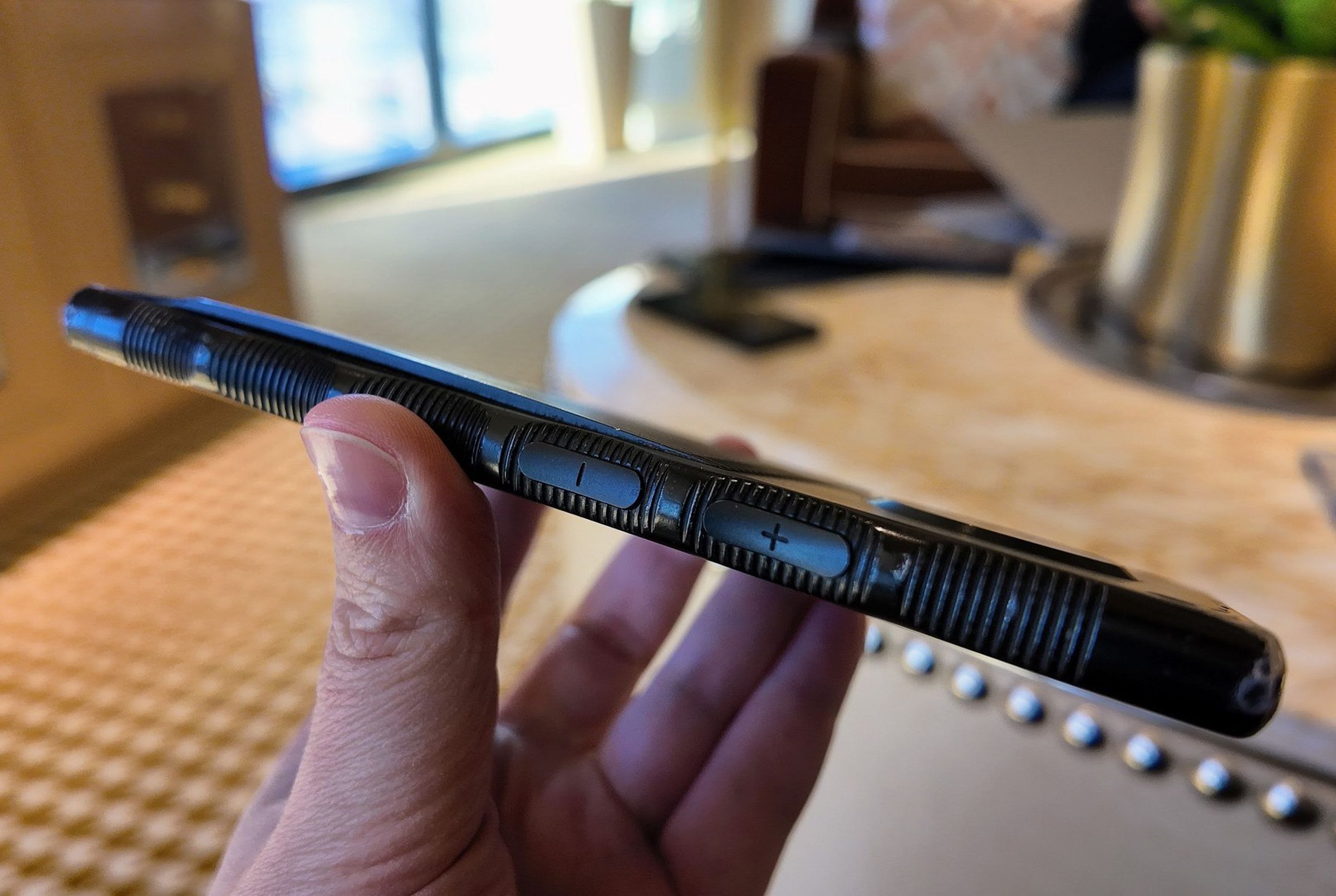The back panel of his Red Hydrogen phone can be seen curving upward away from the main chassis in profile. You can also see the phone’s distinctive scalloped edges, each scallop of which has ridges like a coin inside.
