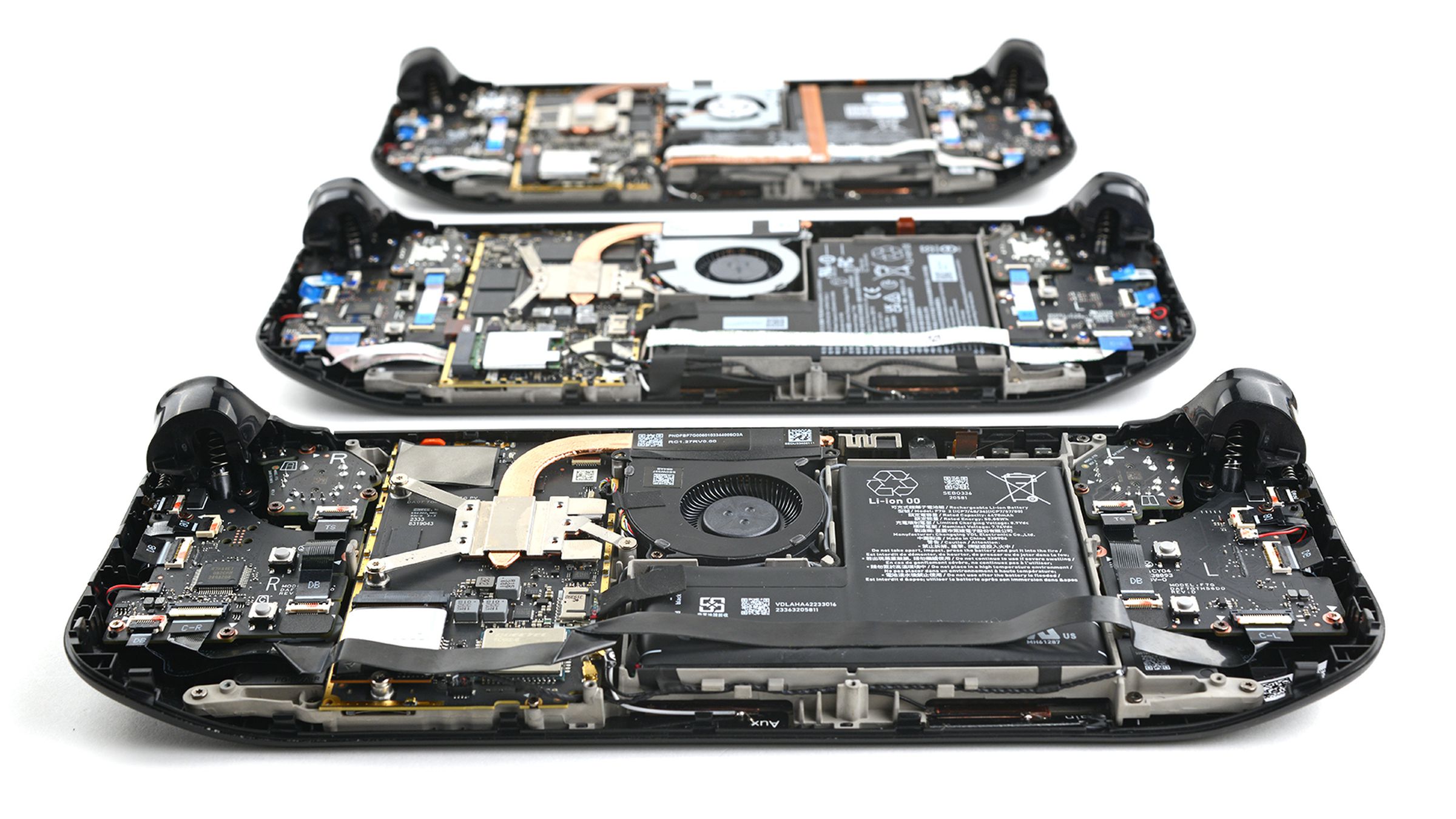 Three disassembled Steam Decks, with the OLED in the front and previous two revisions behind it.