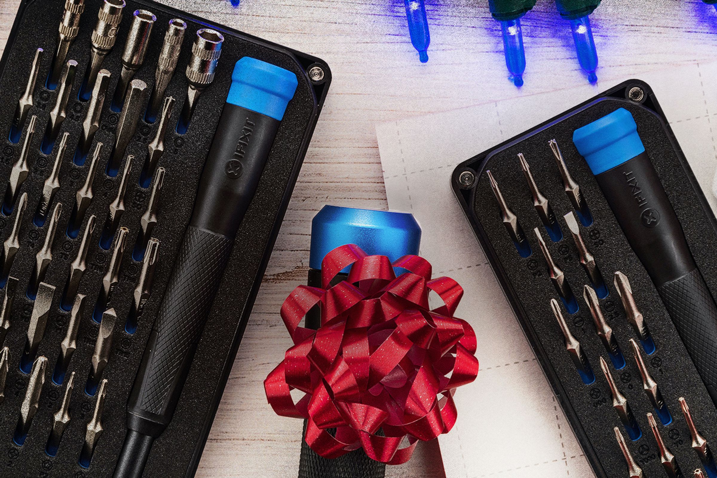 An image of the two new iFixit kits, with a screwdriver wrapped in a bow between them