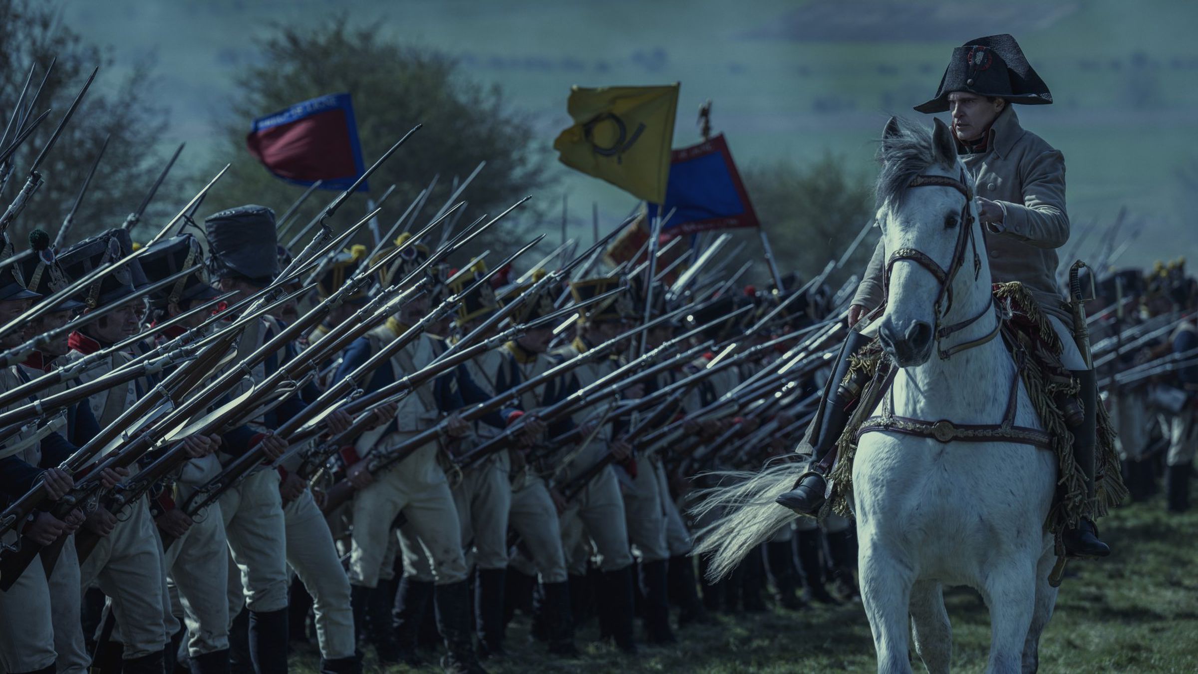 Still from the Apple TV Plus film Napoleon showing the cahracter on horseback in front of an army.