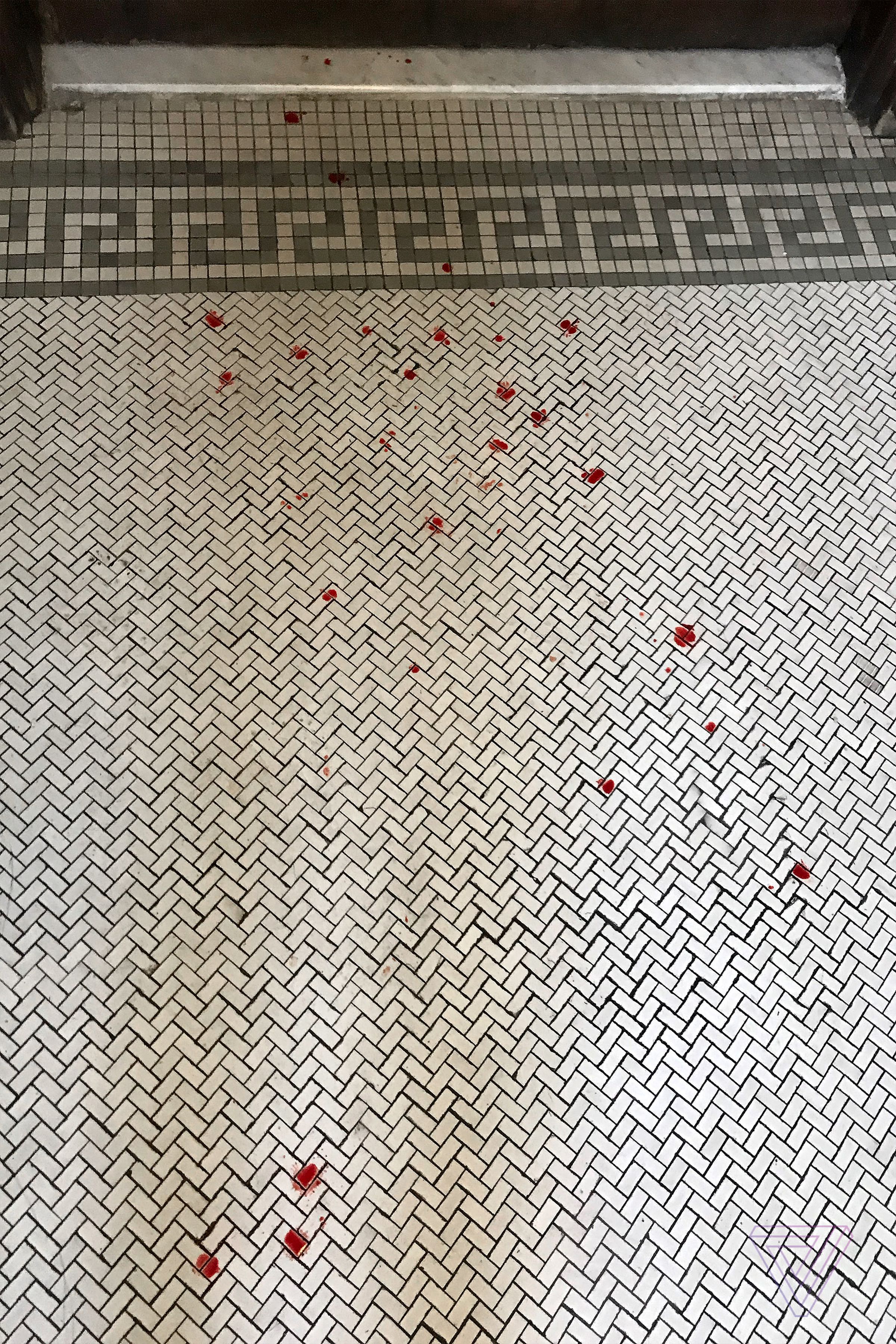 The blood spattered floor in my building’s lobby