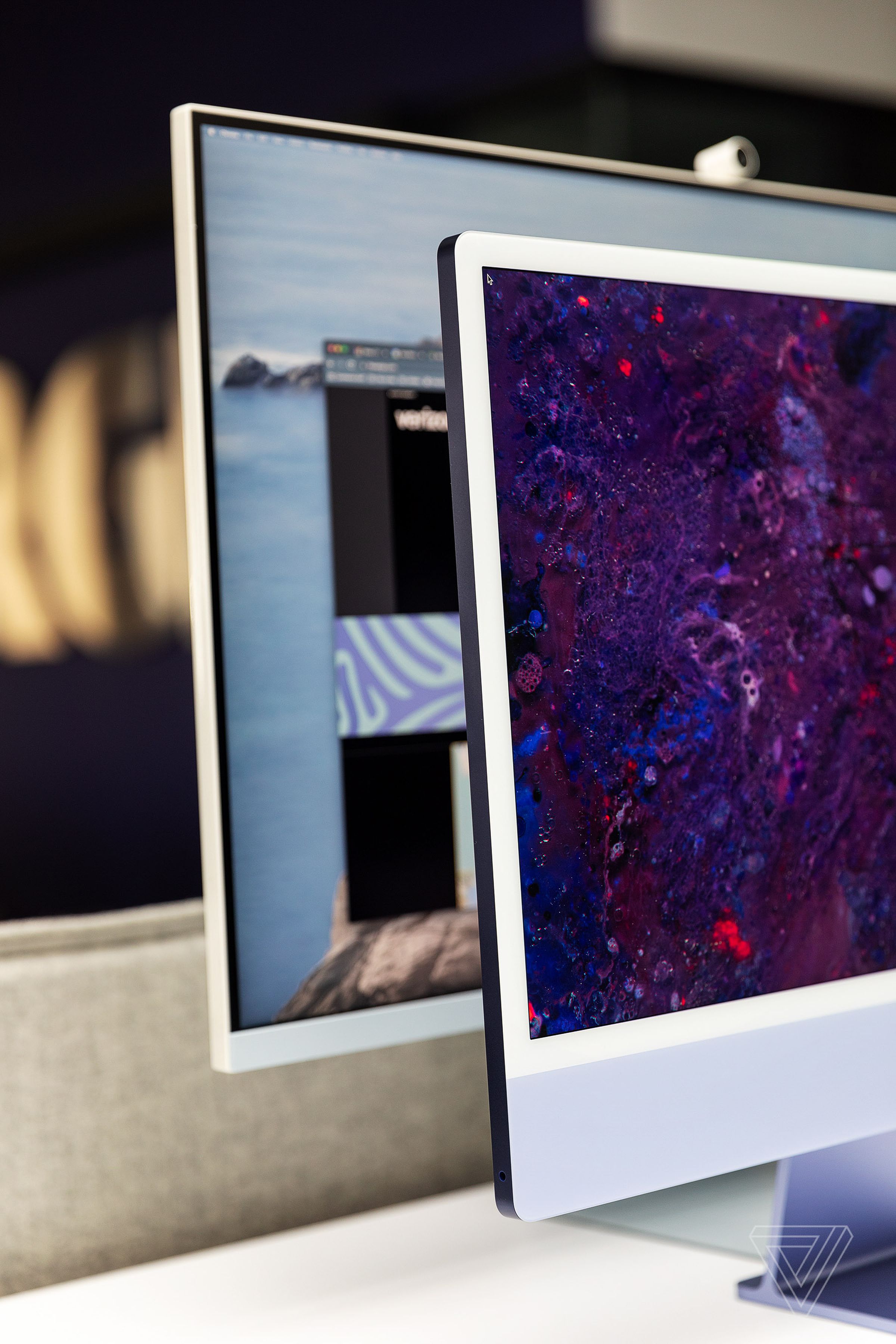 The Samsung M8 smart monitor, background, with an M1 iMac in the foreground, highlighting the similarities in design.