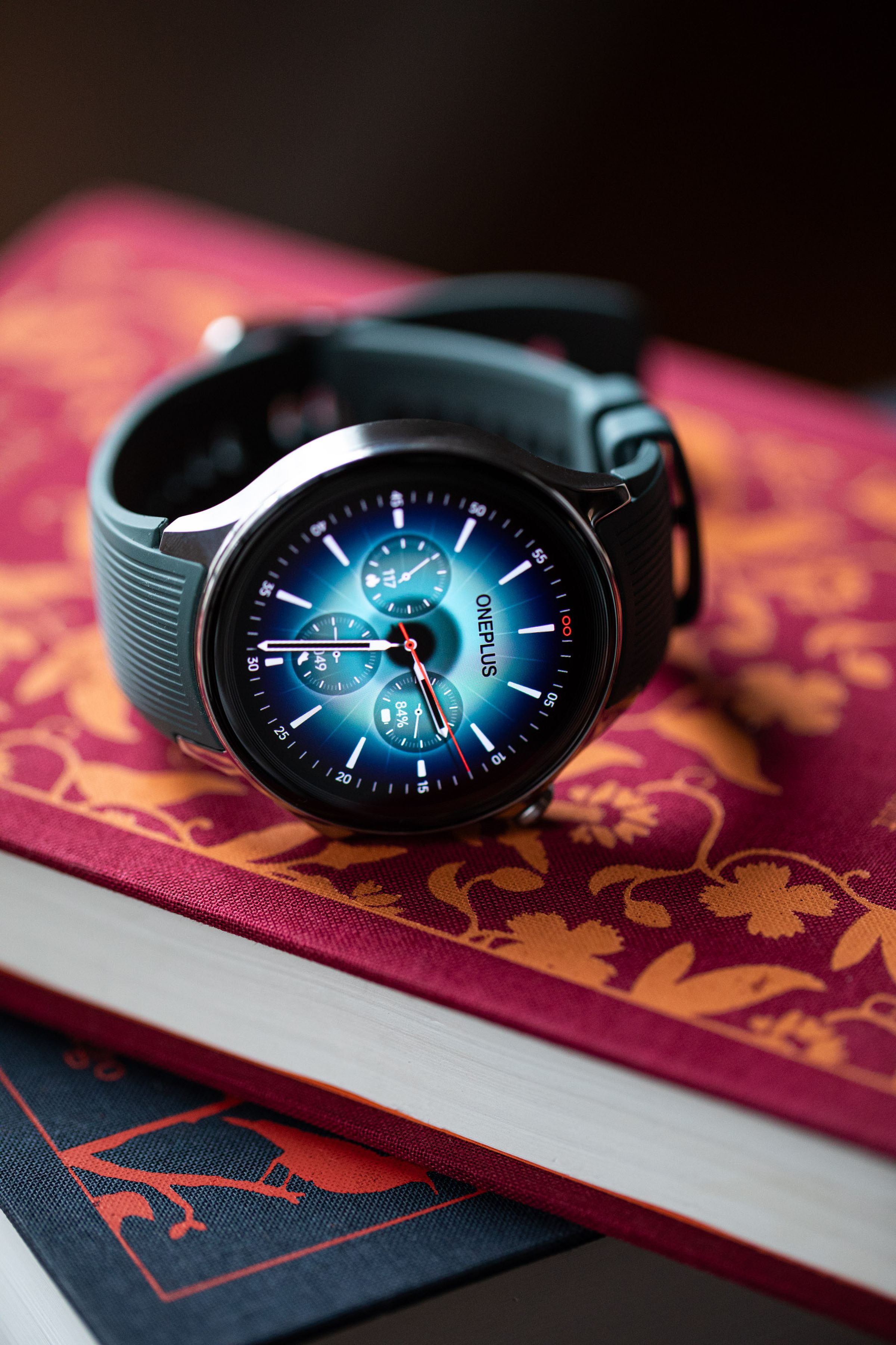 The OnePlus Watch 2 on a stack of books