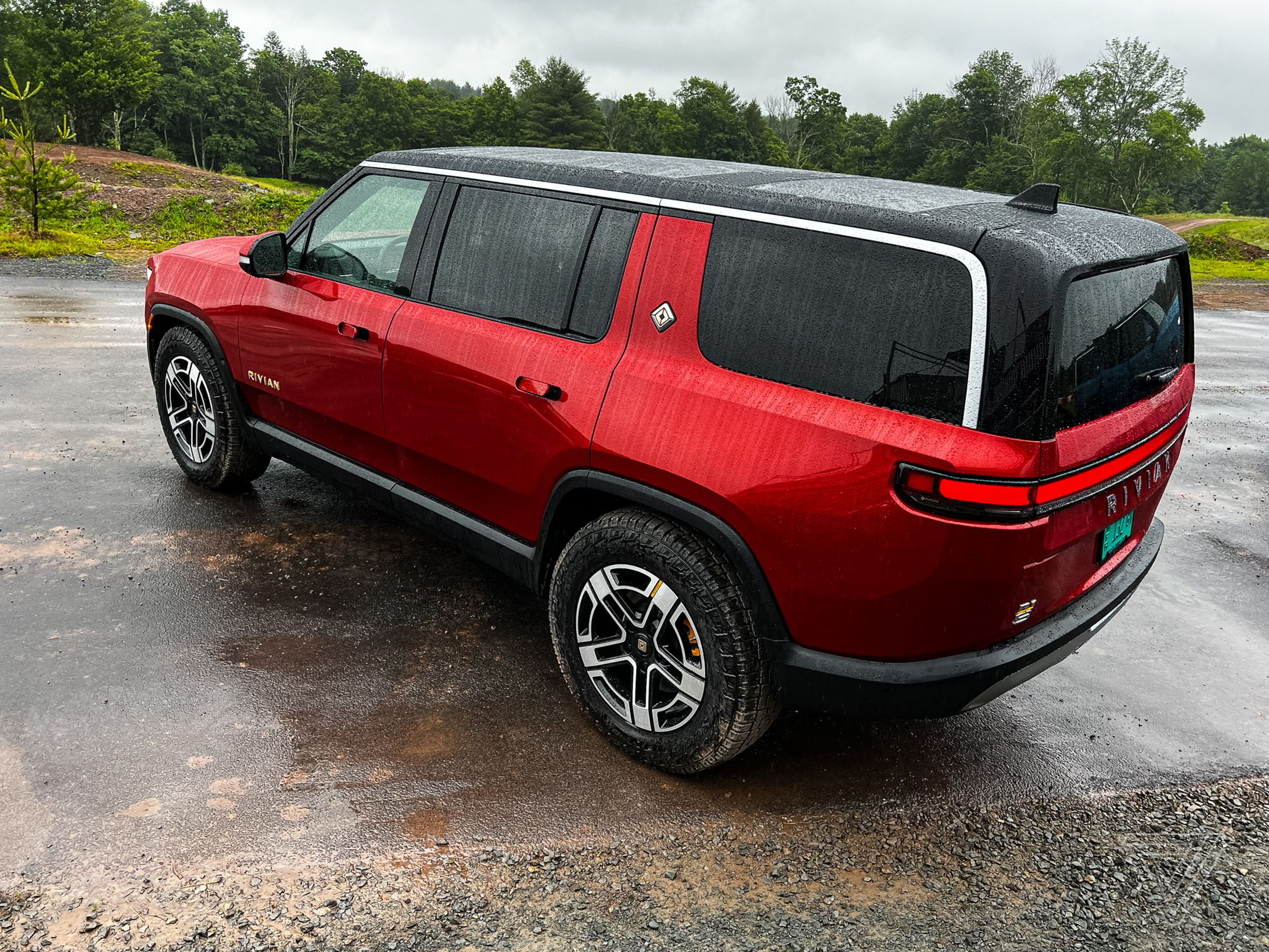A red Rivian R1s from the rear