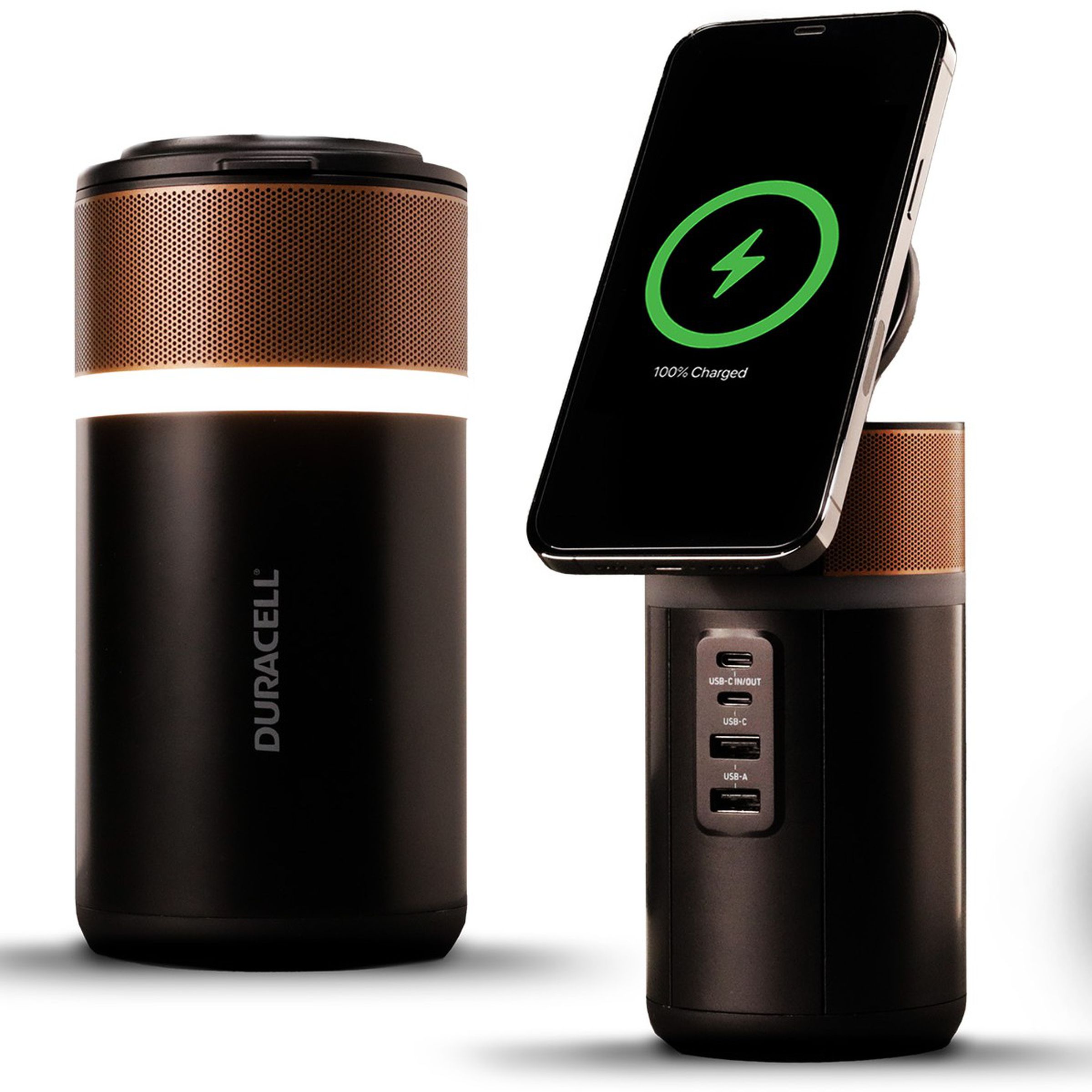 A canister-shaped power tower that looks like a coppertop Duracell battery with four USB ports on the front and a lid that opens to become a wireless charging pad for a phone