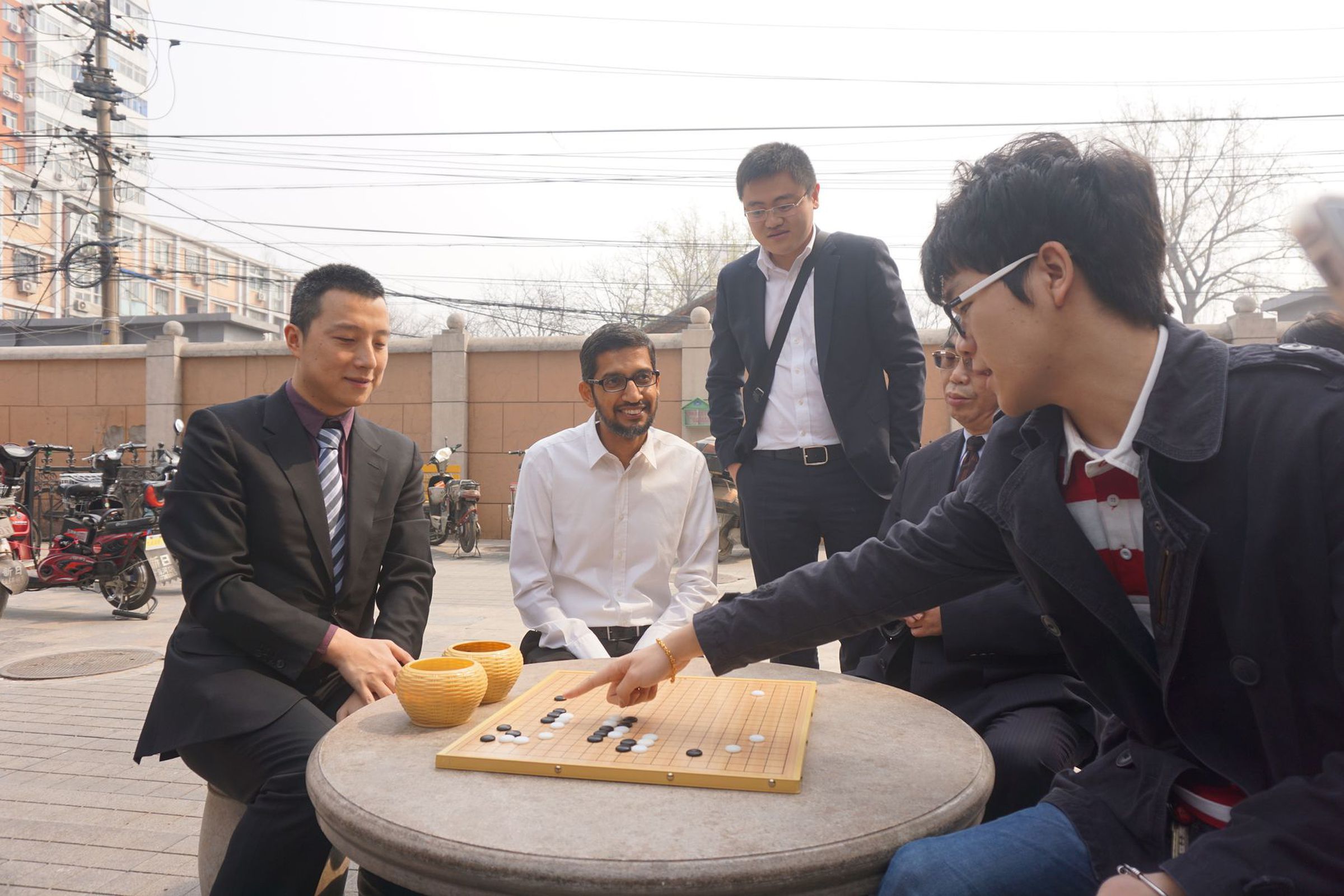 Ke Jie (far right) explains the beauty of AlphaGo's moves to Google CEO Sundar Pichai