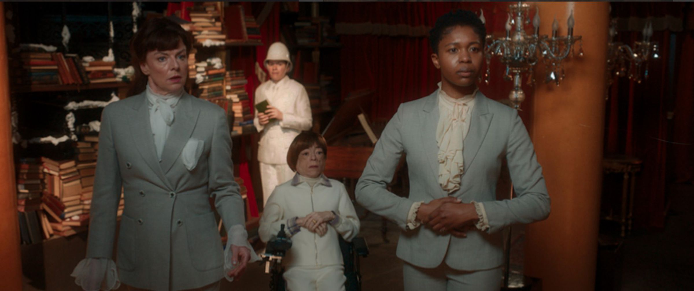A screenshot from Good Omens season 2 showing four angels in a bookshop.
