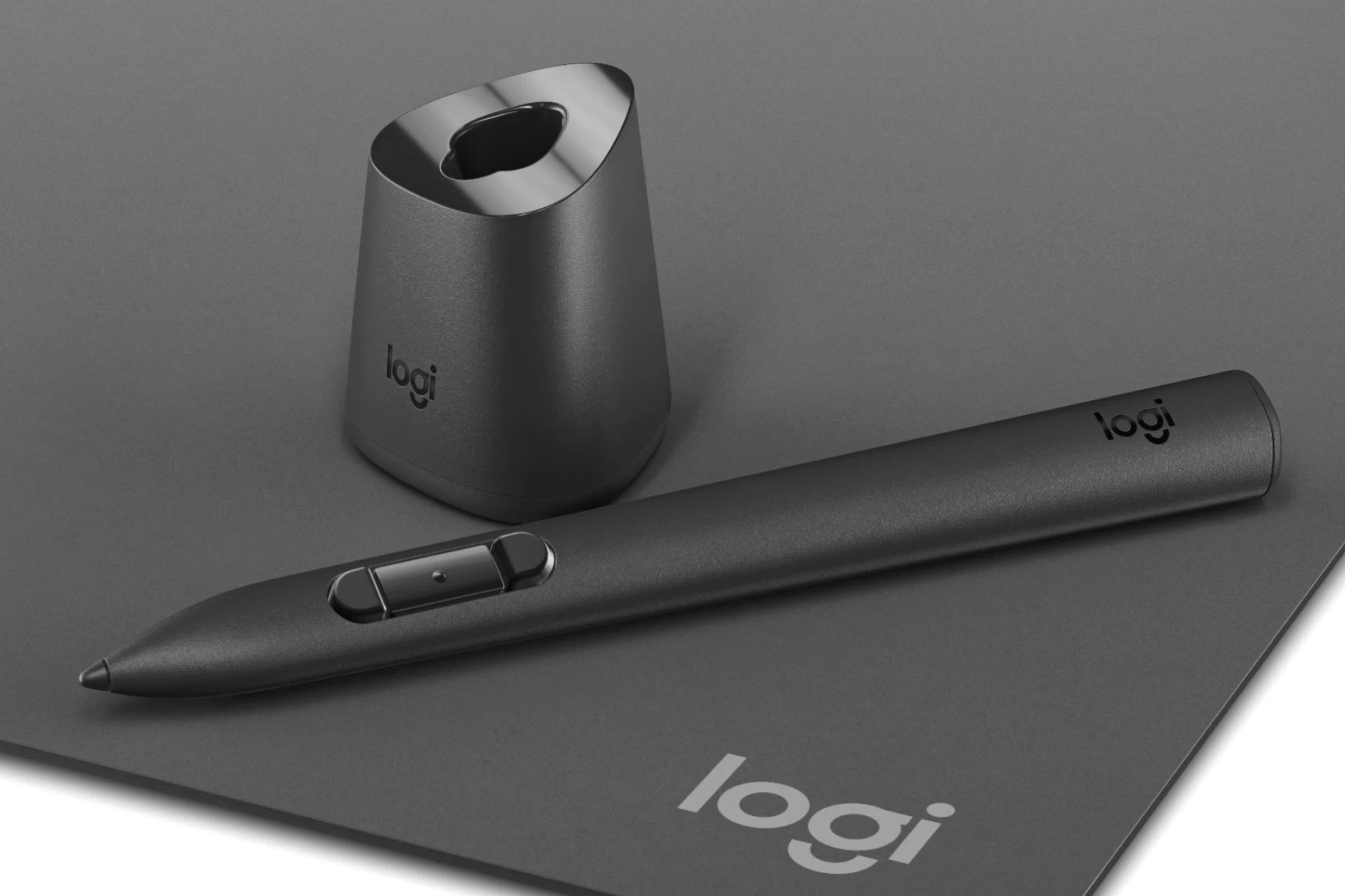 The Logitech MX Ink stylus next to its optional charging dock.
