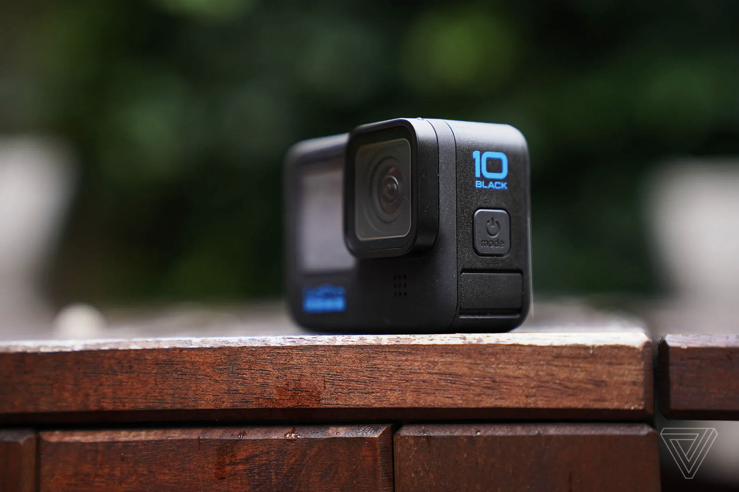 A photo of a GoPro Hero10 Black on a wood table.