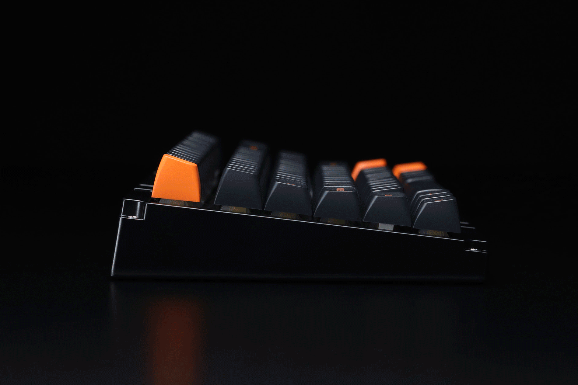 A gif of an orange top case being installed on the keyboard.