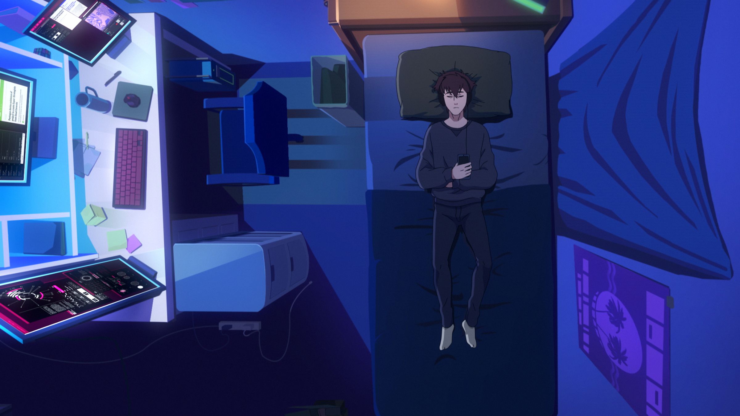 An overhead shot of a boy lying on his bed in a dark room lit only by the screens of his computer setup to the side of him.
