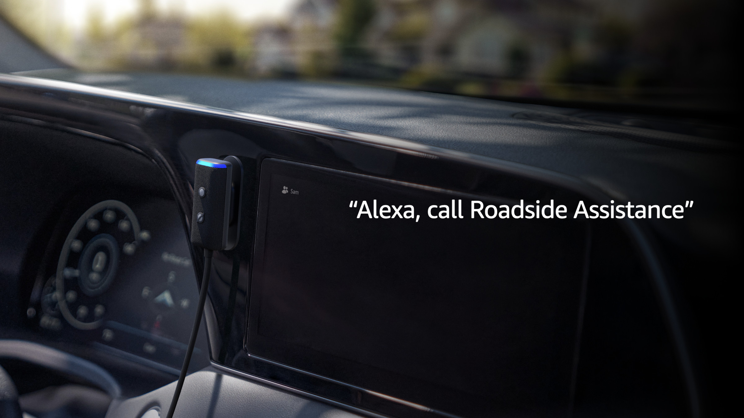 An image of the new Amazon Echo Auto mounted on a car’s dashboard with the text Alexa, Call Roadside Assistance overlaid on top.