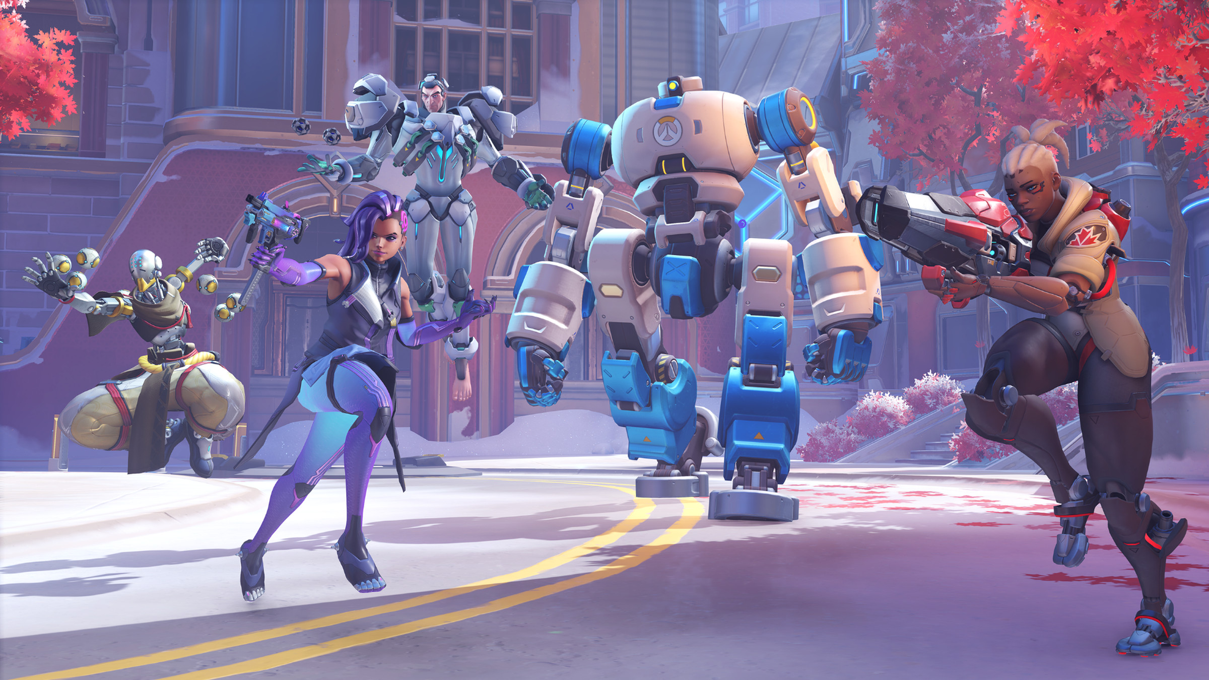 Screenshot from Overwatch 2 displaying the newest map type, Push featuring several Overwatch 2 heroes from left to right Zenyatta, Sigma, Sombra, and Sojourn flanking a bulky and slow robot designed to push barricades.