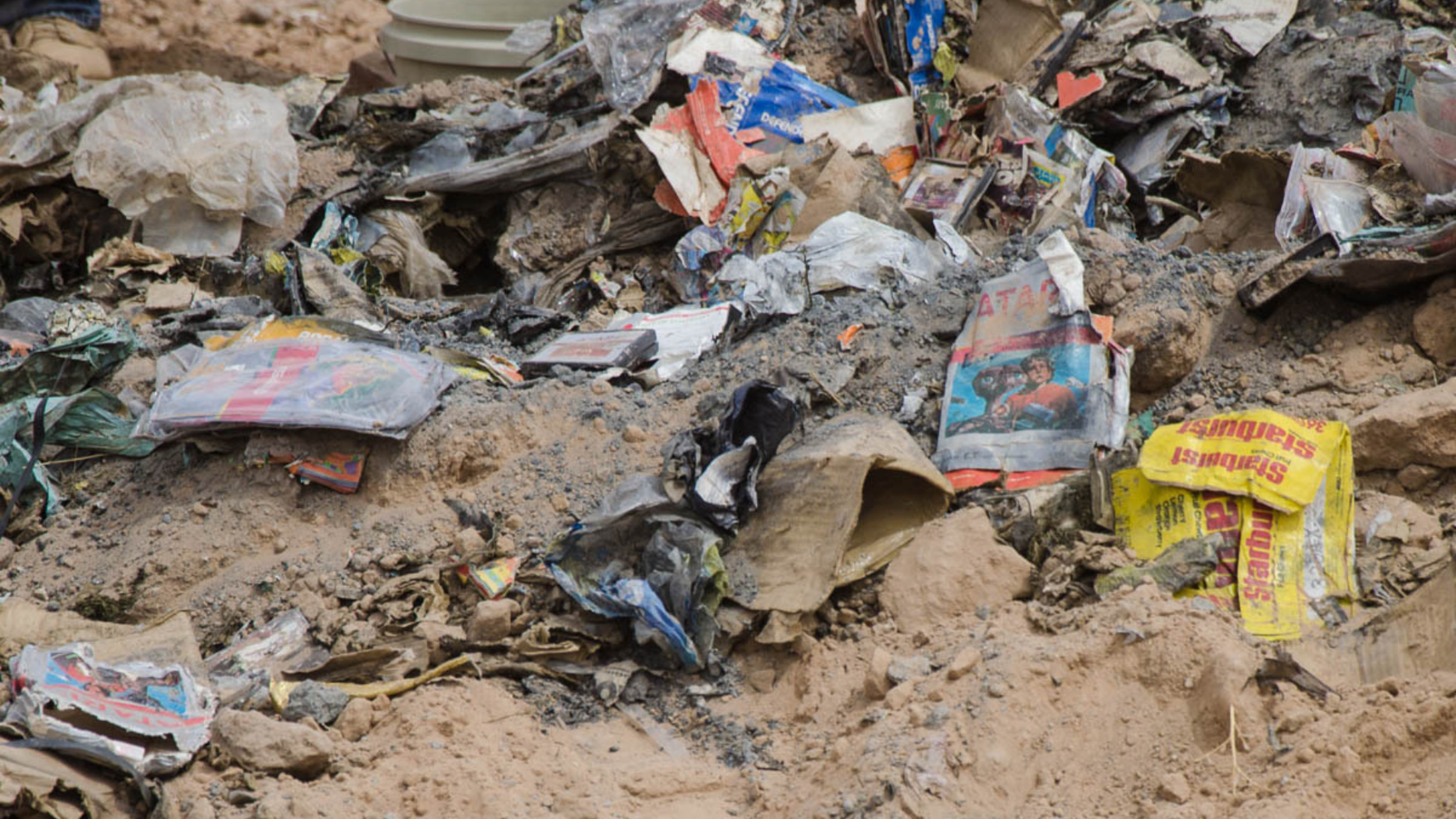 Photo of the infamous Atari video game landfill burial featuring numerous Atari video game boxes half buried in a landfill in New Mexico